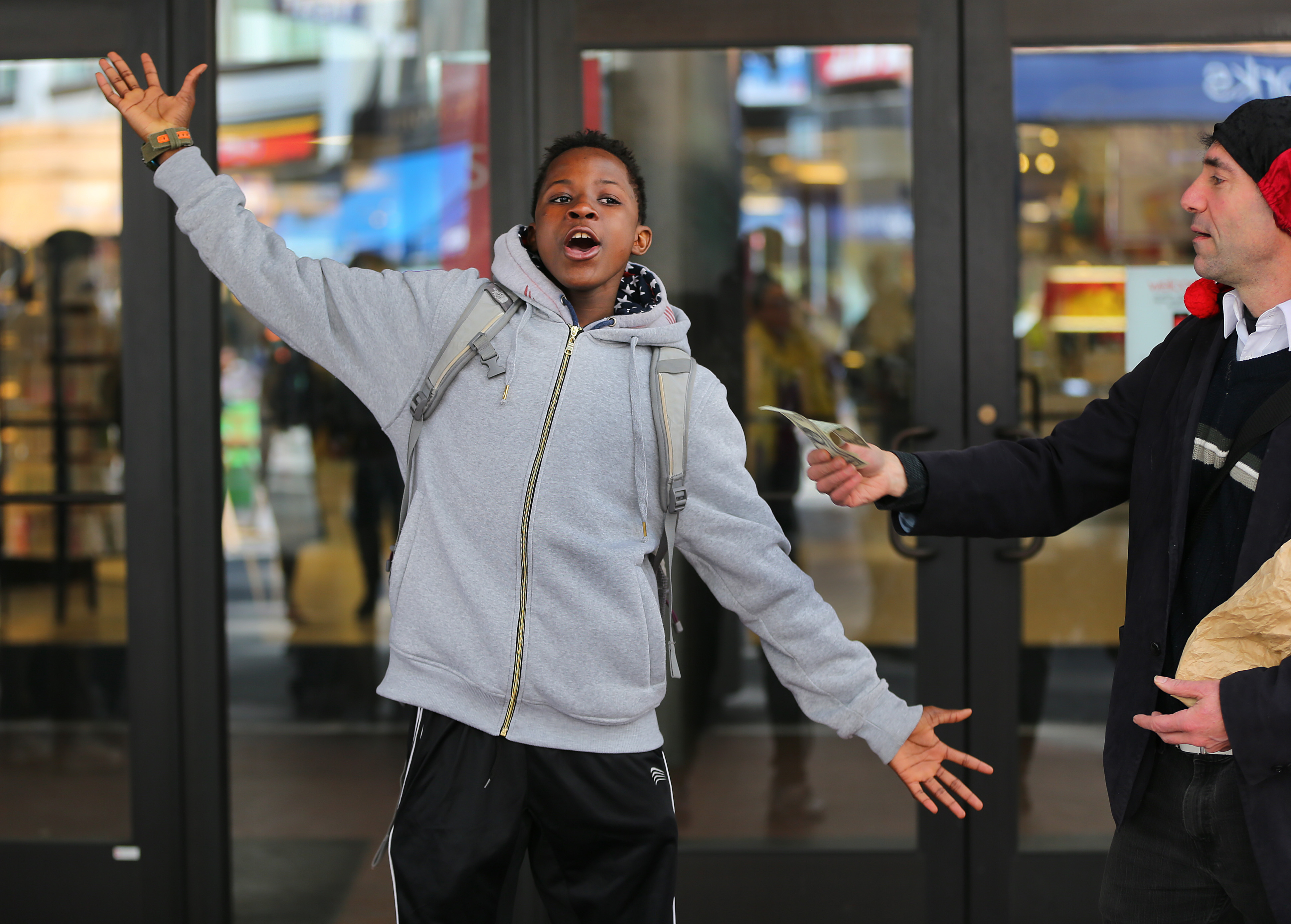 Reneil Miller, 15 from Boston did a short performance to earn his dollar from Alex Feldman.