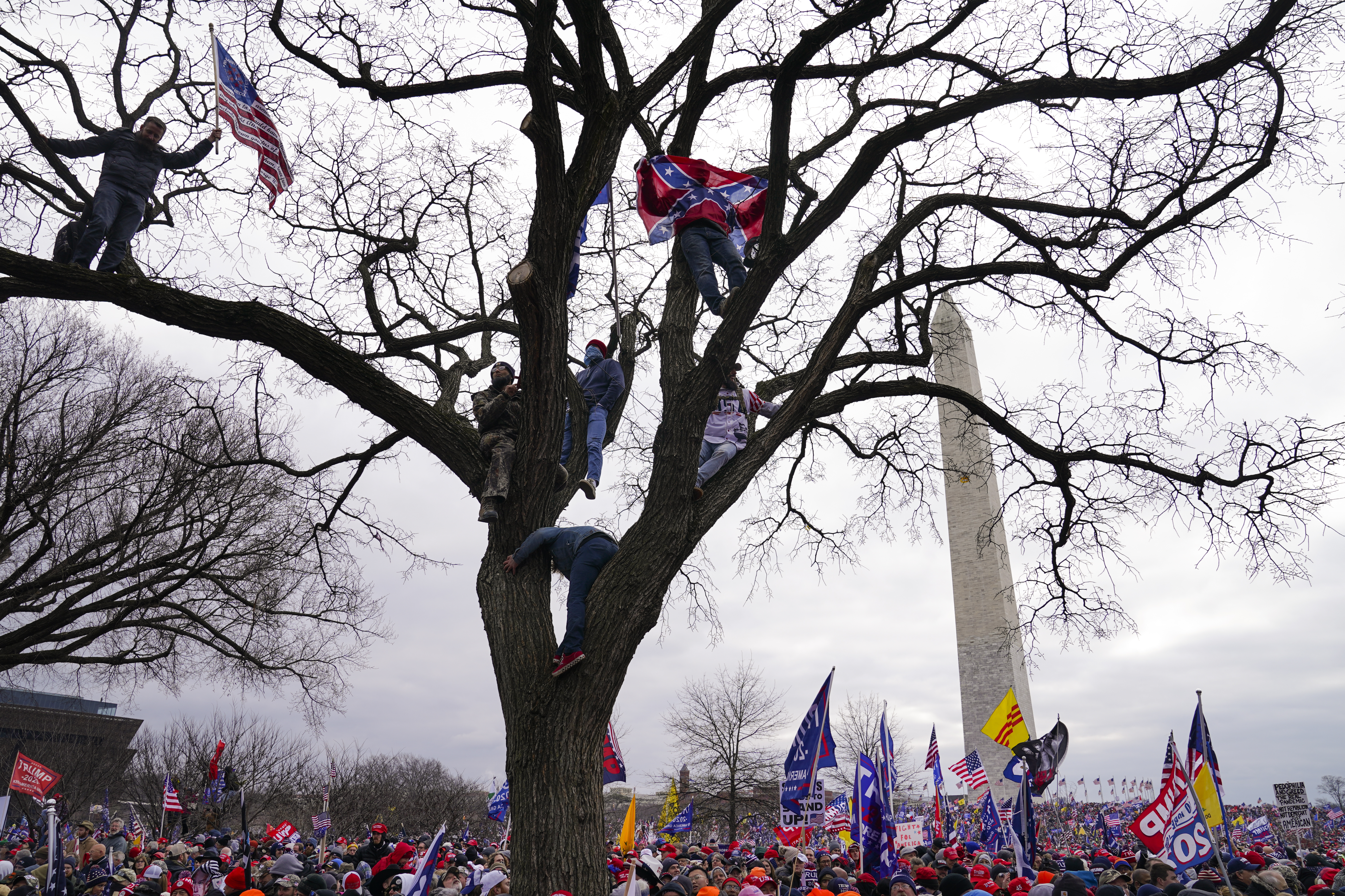 FILE - Supporters of President Donald Trump participate in a rally in Washington on Jan. 6. Both within and outside the walls of the Capitol, banners and symbols of white supremacy and anti-government extremism were displayed as an insurrectionist mob attacked the US Capitol.