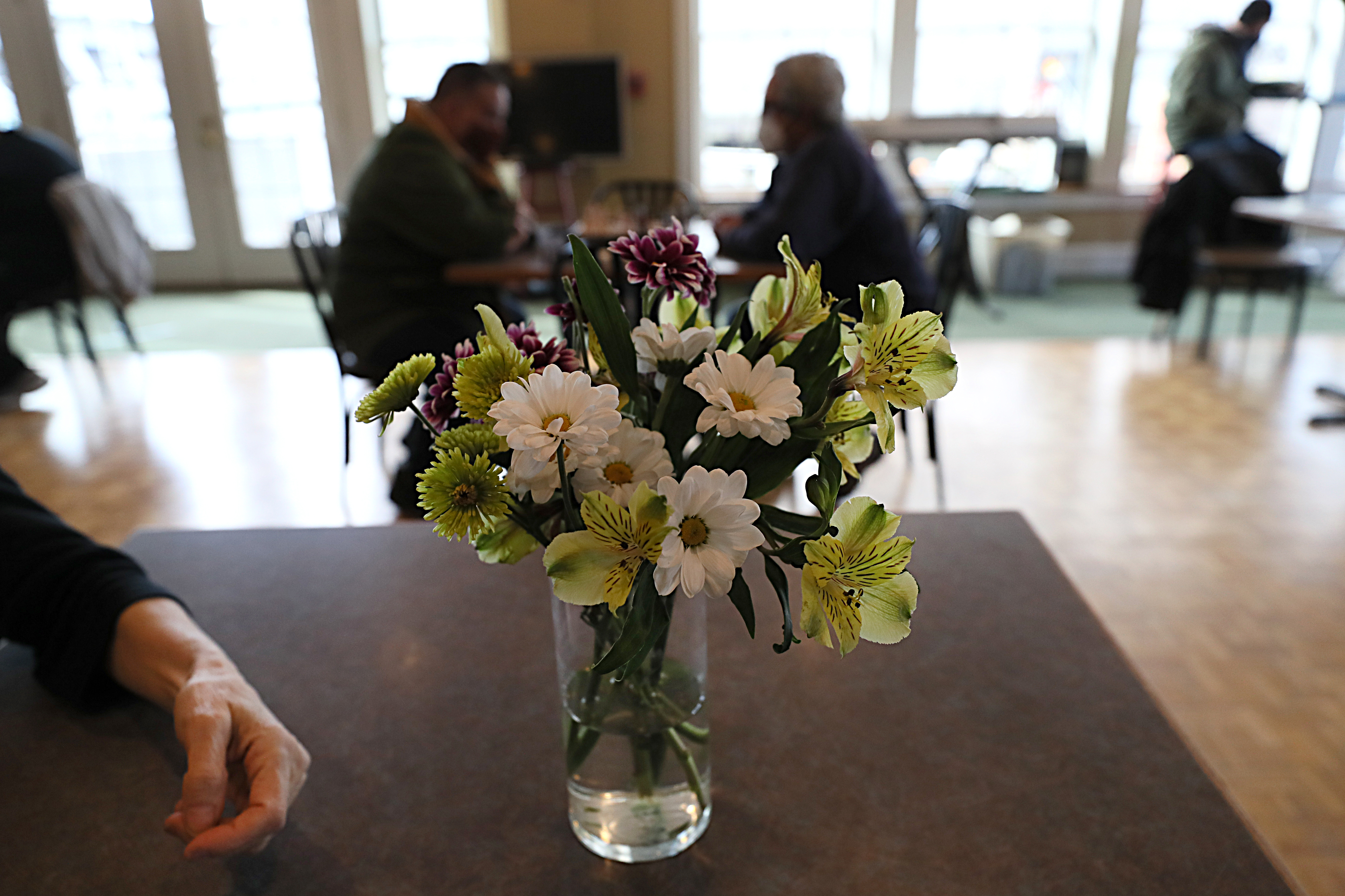 Relocating to a space normally used for weddings and other special occasions gives the Grace Center’s approximately 50 daily guests the chance to enjoy such amenities as a fireplace, banquet tables decked with flowers, and waterfront scenery.