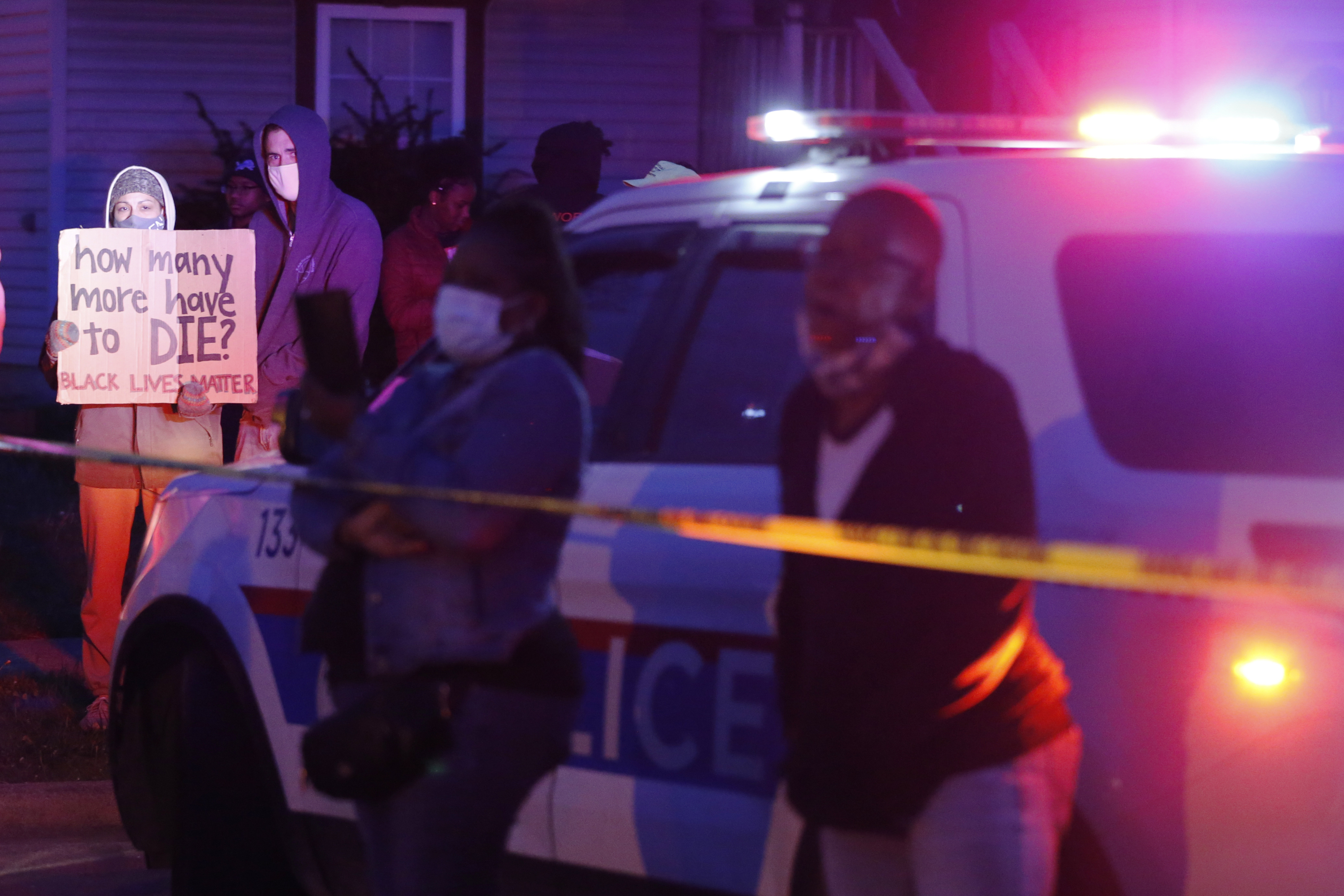 A crowd gathered to protest in the neighborhood where a Columbus police officer fatally shot a teenage girl in Columbus, Ohio.
