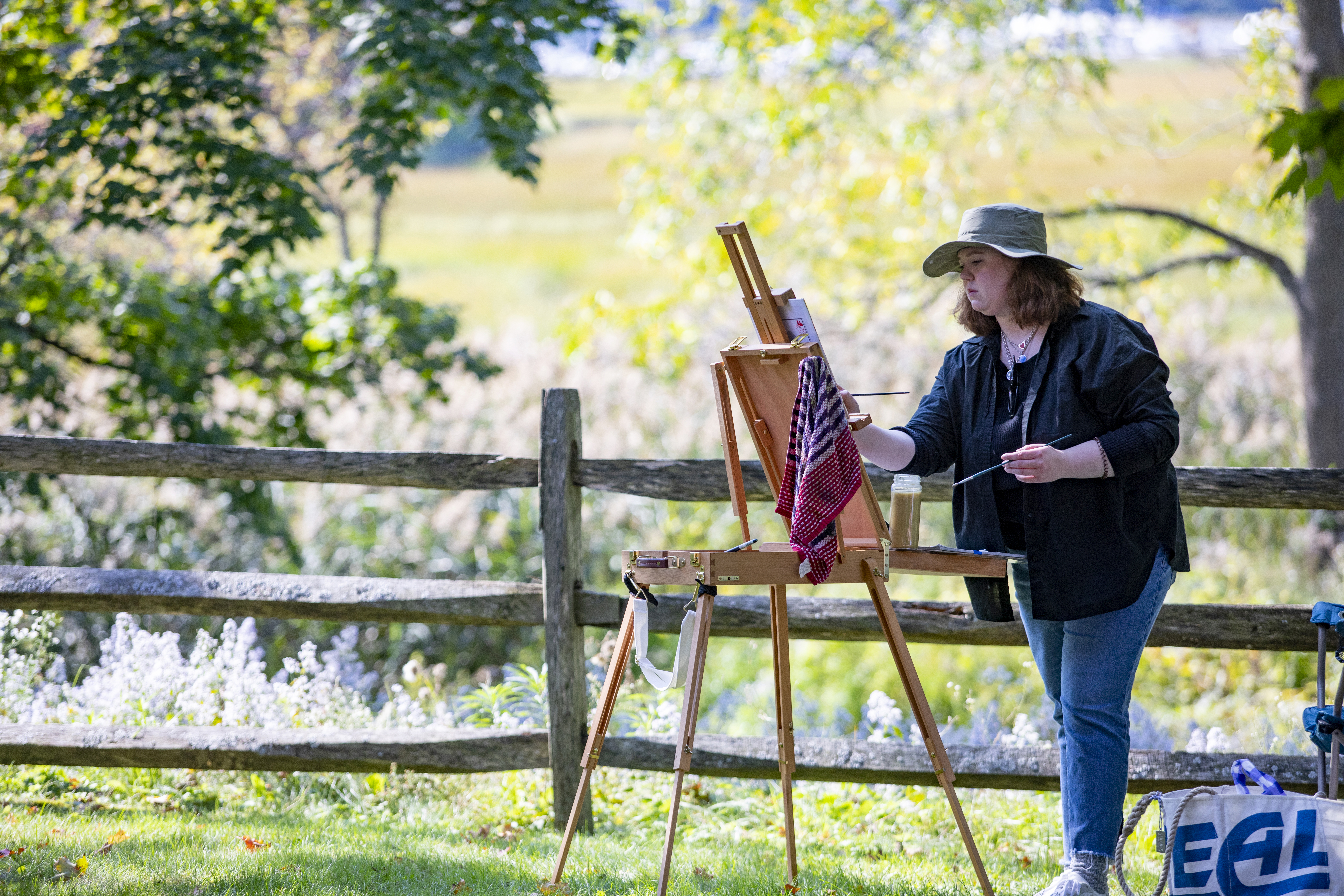 Meghan Messer of Dracut paints during an outdoor painting class at Cogswell's Grant in Essex.
