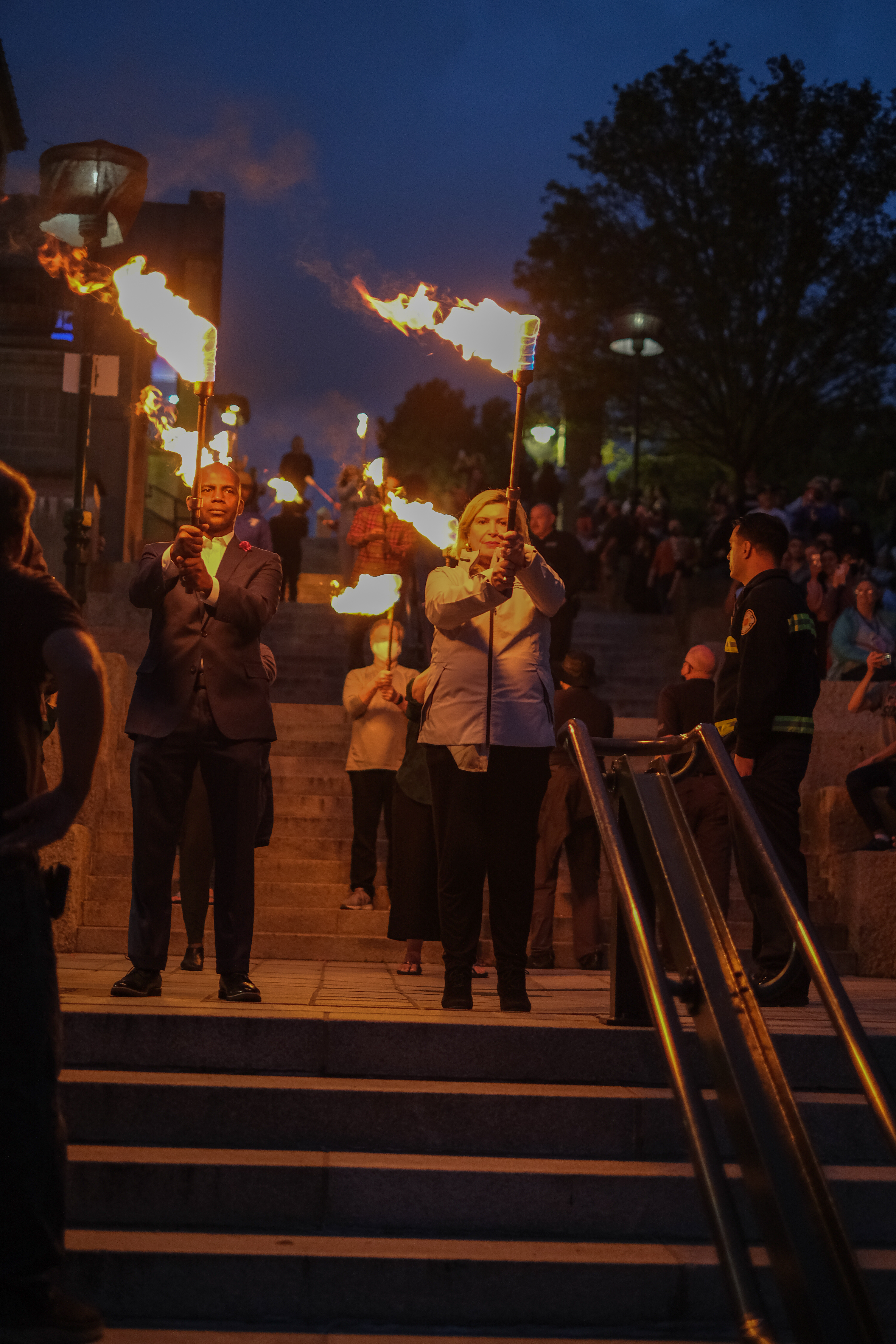 Barbara Papitto, right, and Arnell Milhouse of The Papitto Opportunity Connection prepare to light a special Waterfire to promote and celebrate BIPOC residents, with music and performances by BIPOC in Providence, R.I. on Saturday, October 16 2021. (Photo/Joe Giblin)