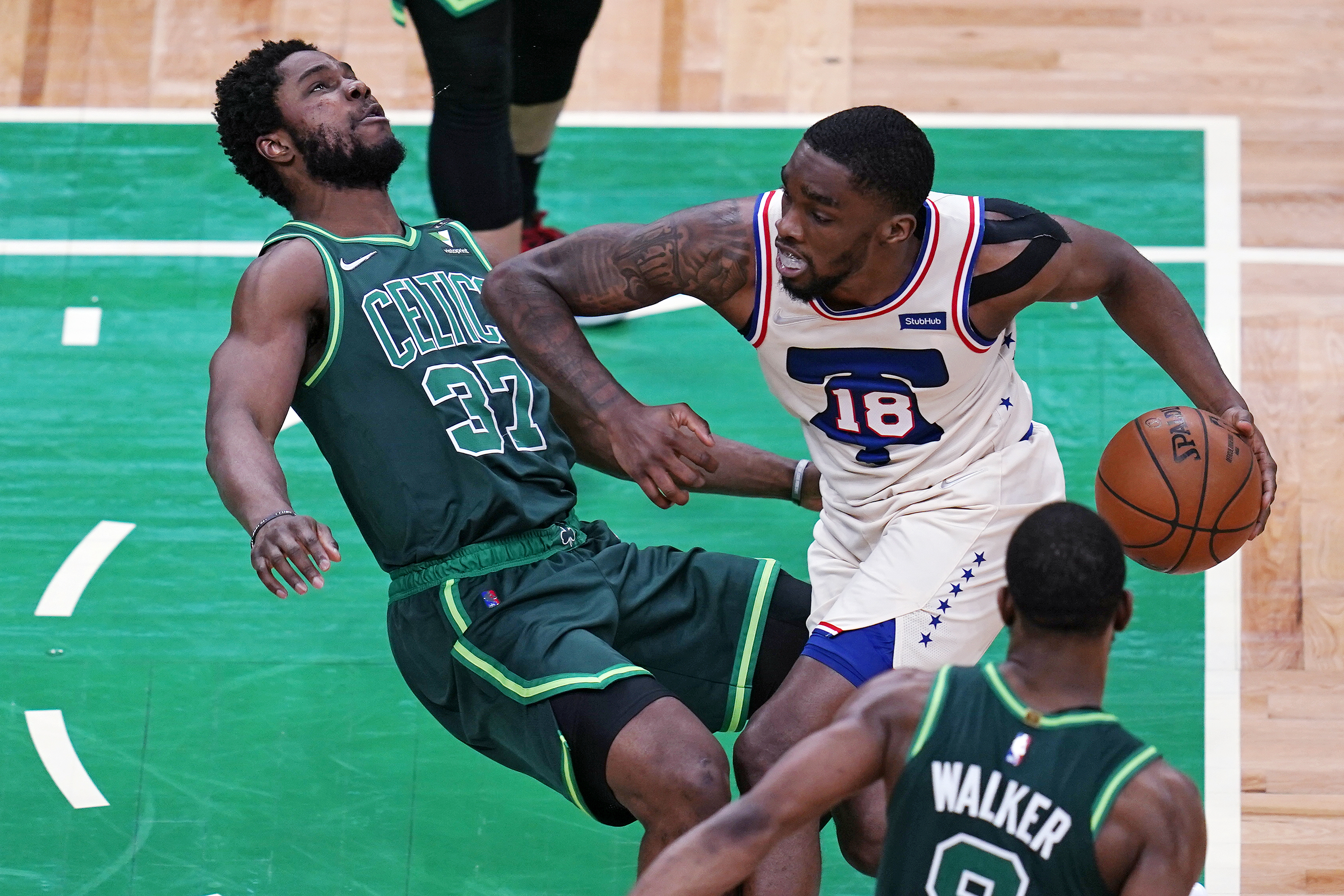 Philadelphia's Shake Milton charges into Semi Ojeleye during the second half of Tuesday's contest.