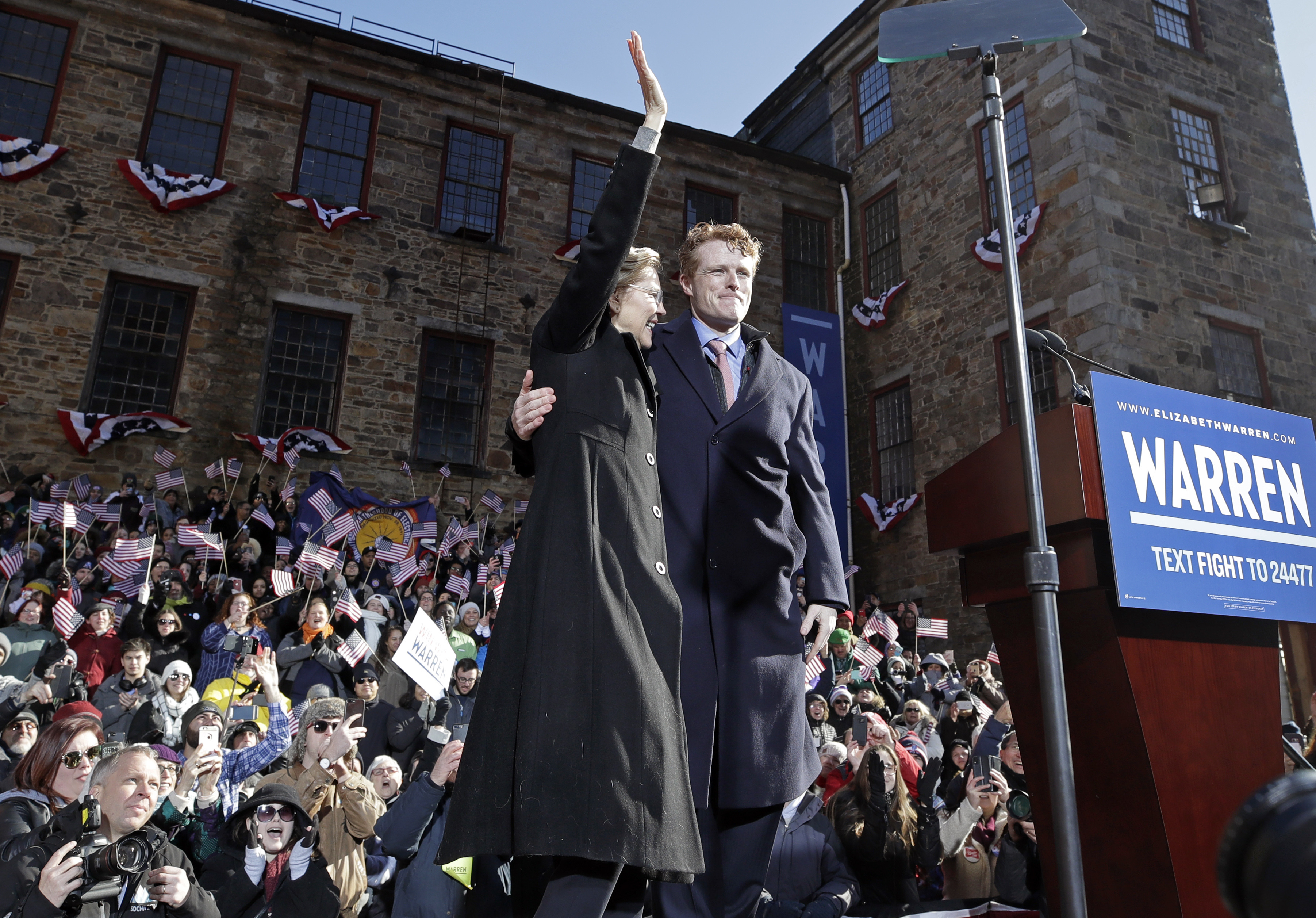 Senator Elizabeth Warren waved next to Representative Joseph Kennedy III after he introduced her during an event to formally launch her presidential campaign on Feb. 9, 2019, in Lawrence, Mass.