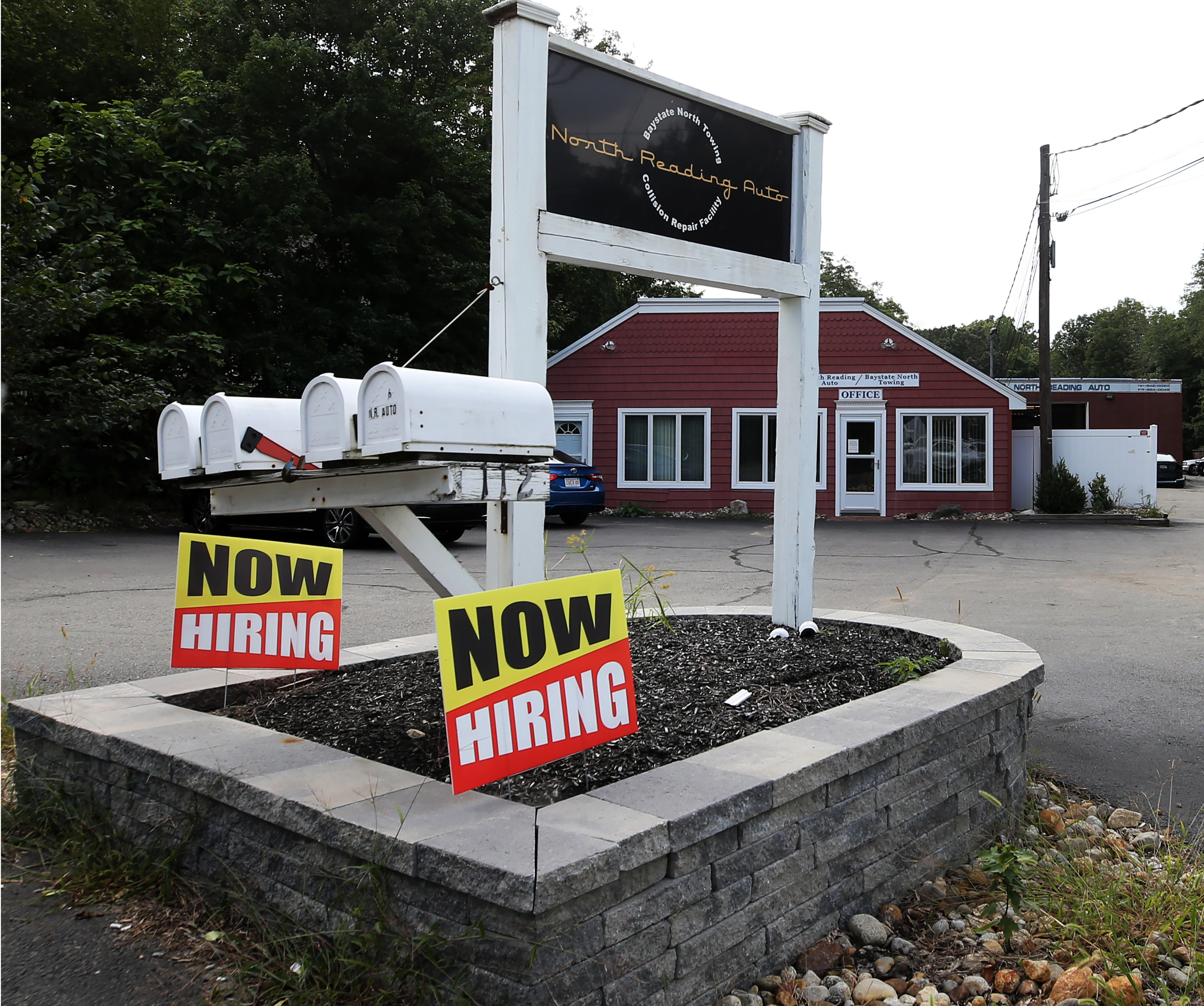 Signs seeking help wanted at North Reading Auto.