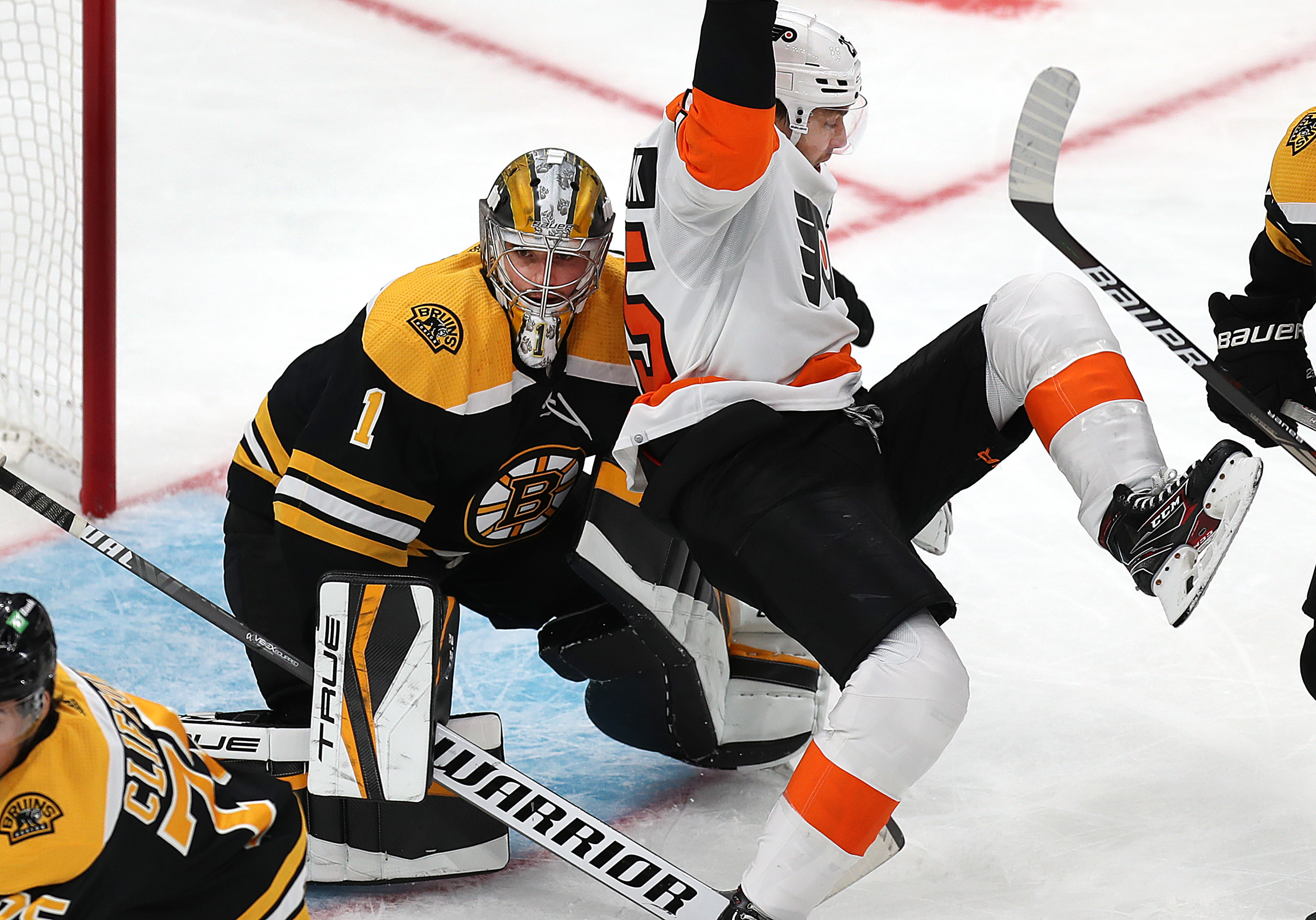 The 22-year-old Jeremy Swayman, seen here cleaning the crease during a preseason game against the Flyers, will start in goal for the Bruins when they open the regular season.