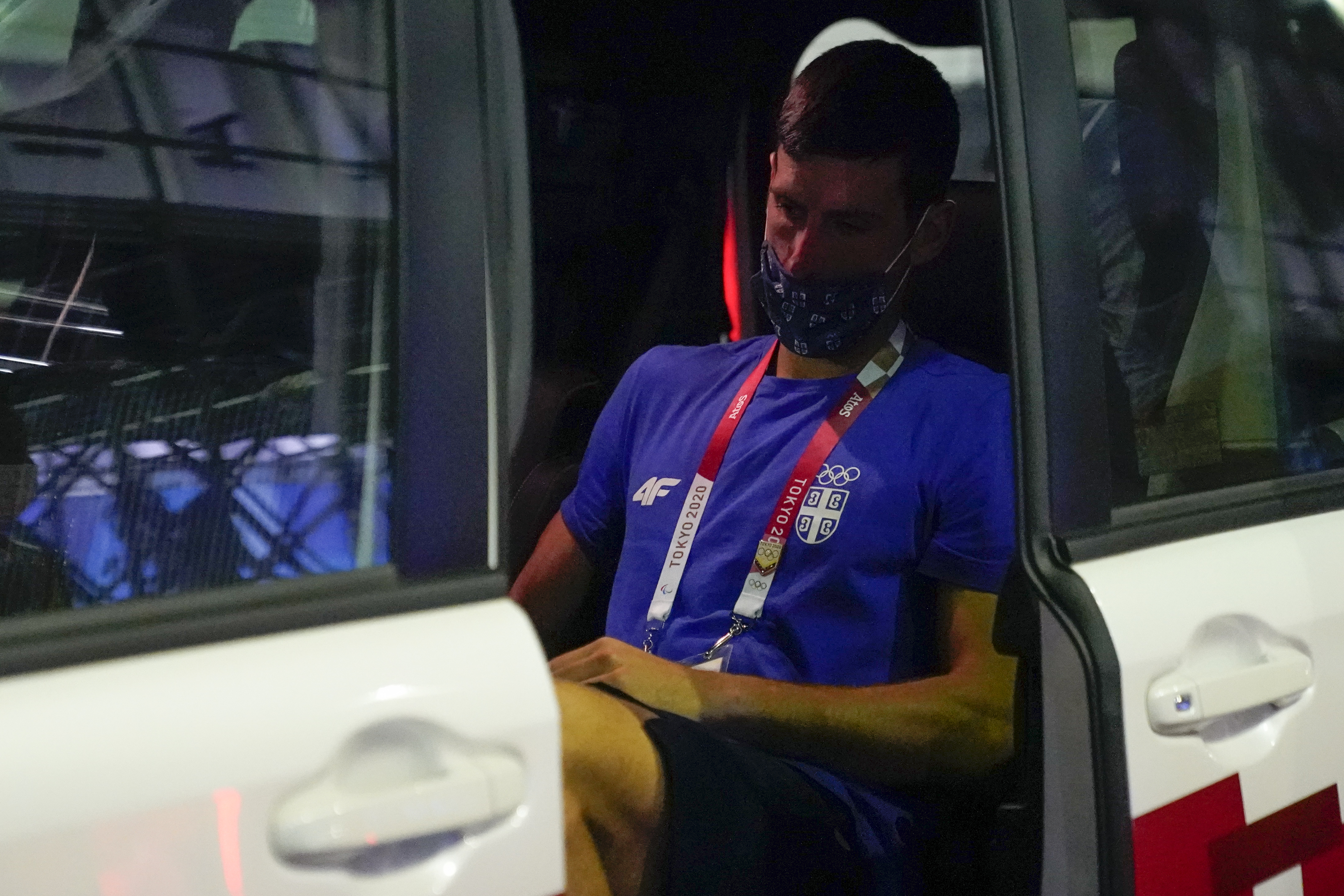 A glum Novak Djokovic departs the Ariake Tennis Center after his loss to Pablo Carreno Busta.