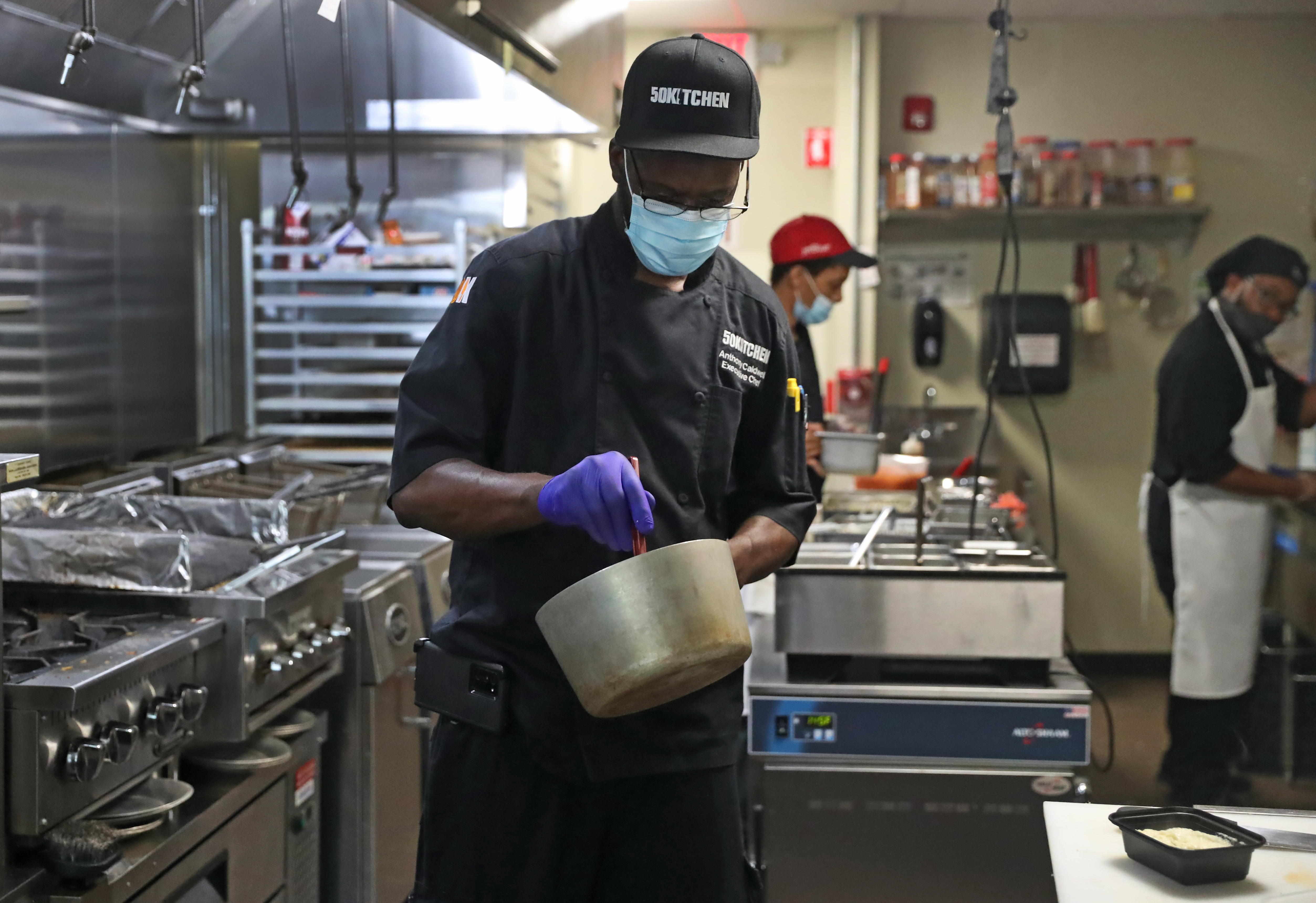 At 50Kitchen in Dorchester, chef-owner Anthony Caldwell prepares a meal in the restaurant's kitchen.
