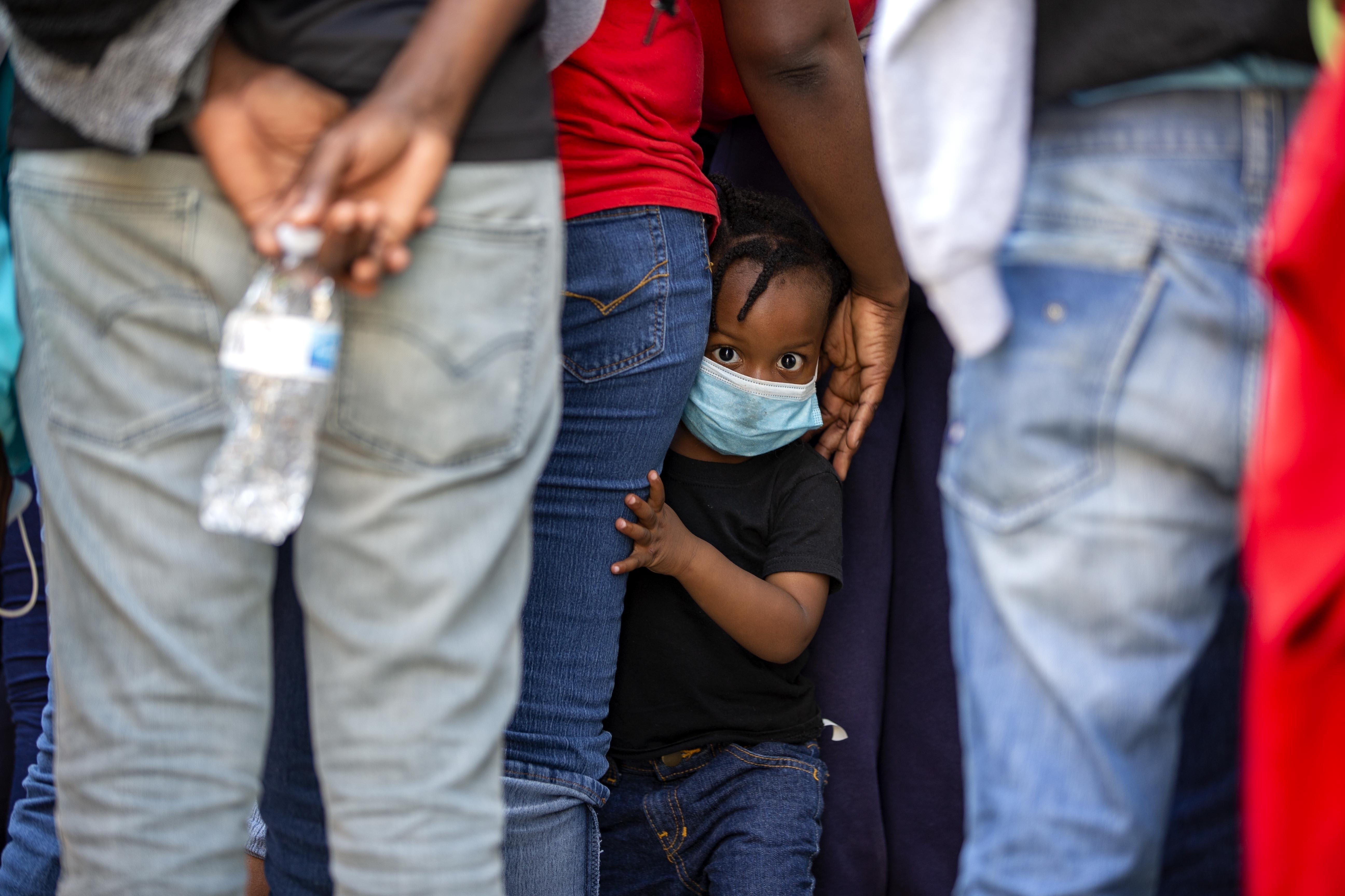 Haitians who were deported from the United States line up as they arrive at a hotel where they will be quarantined as a measure against the spread of the new coronavirus, in Tabarre, Haiti, April 23.
