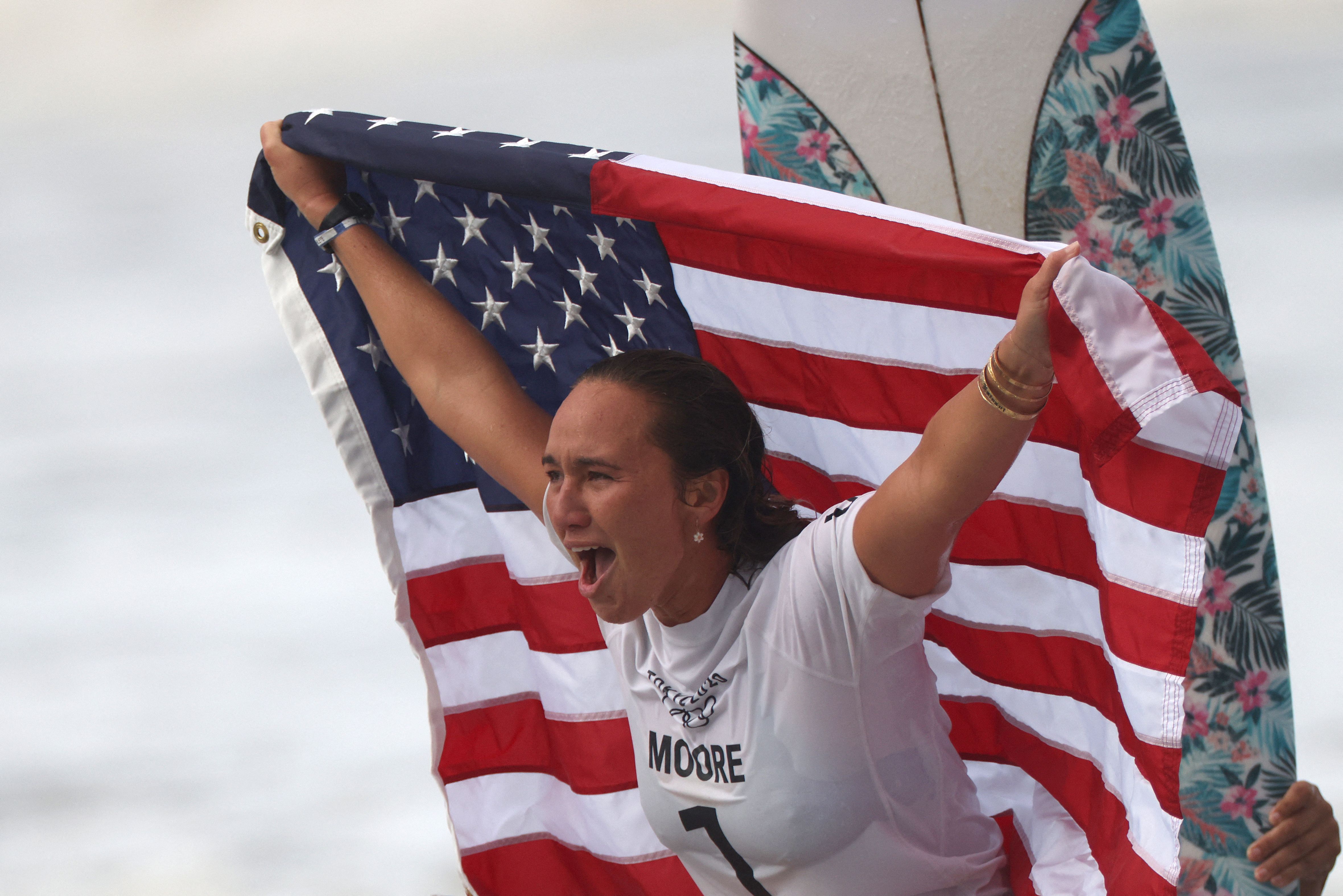 Moore celebrates her triumph in flag-waving style.