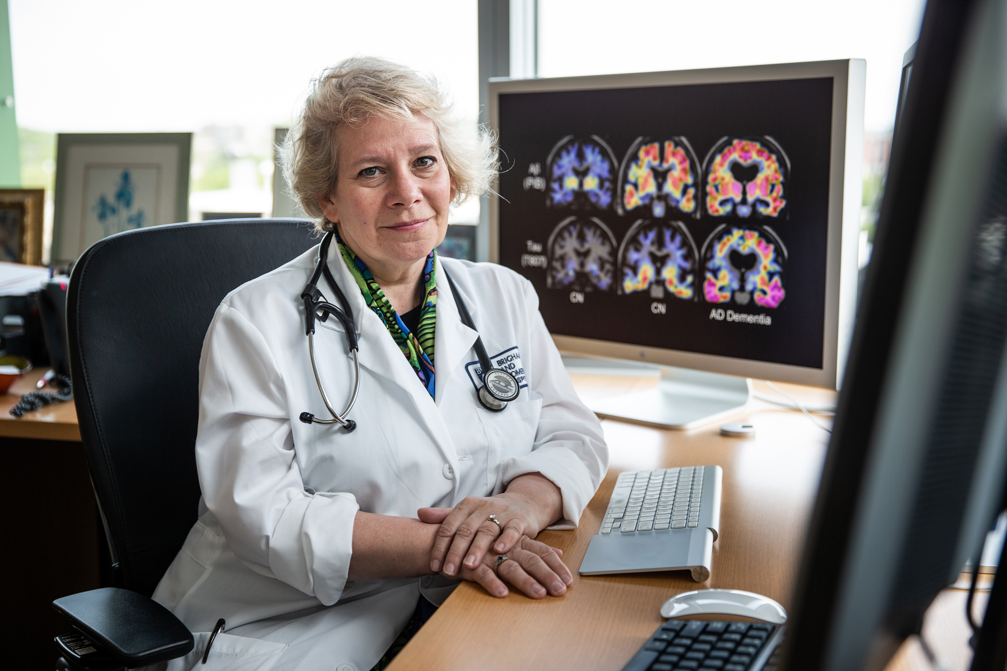 05/16/2018 BOSTON, MA Dr. Reisa Sperling (cq) poses for photos in her office with PET scans on her computer at Brigham and Women's Hospital in Boston. (Aram Boghosian for The Boston Globe)