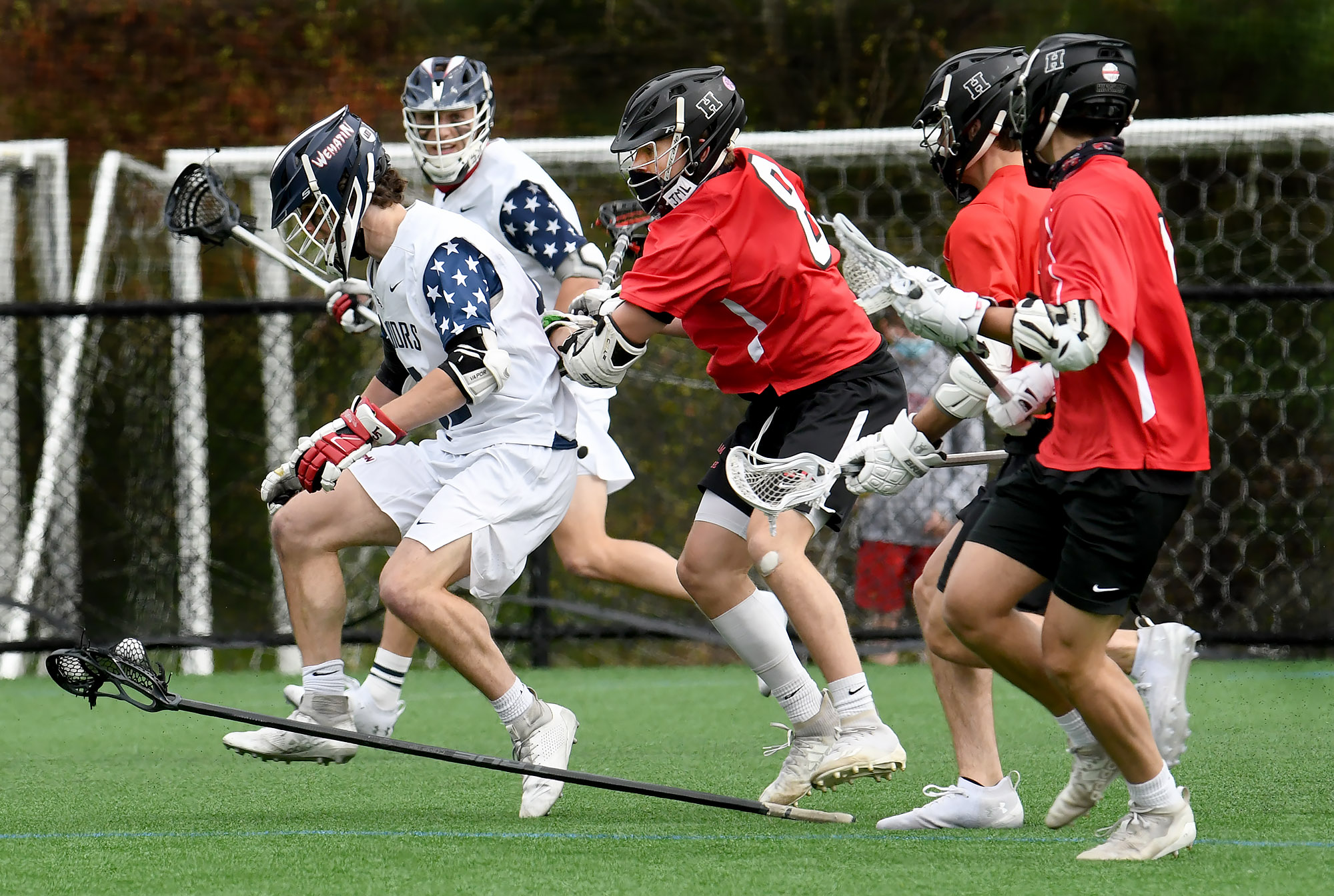 Lincoln-Sudbury’s Brian Barringer loses control of his stick while being chased by a trio of Hingham defenders Saturday afternoon.