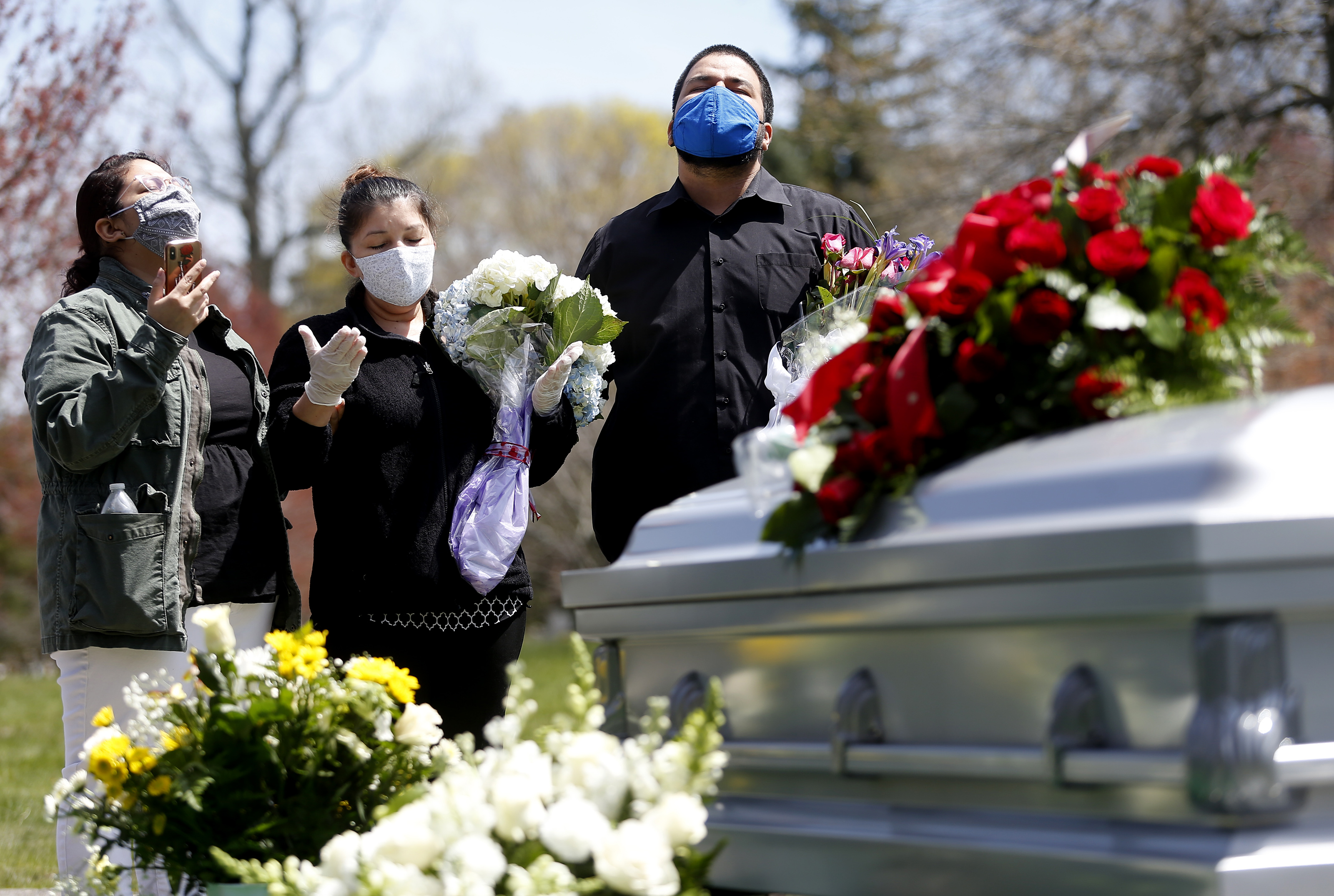 Vanessa Rivas prayed alongside her mother, Rosa A. Martinez Rivas, and brother Danny A. Rivas during the funeral service for her father, Santos A. Rivas, who died after a battle with COVID-19.