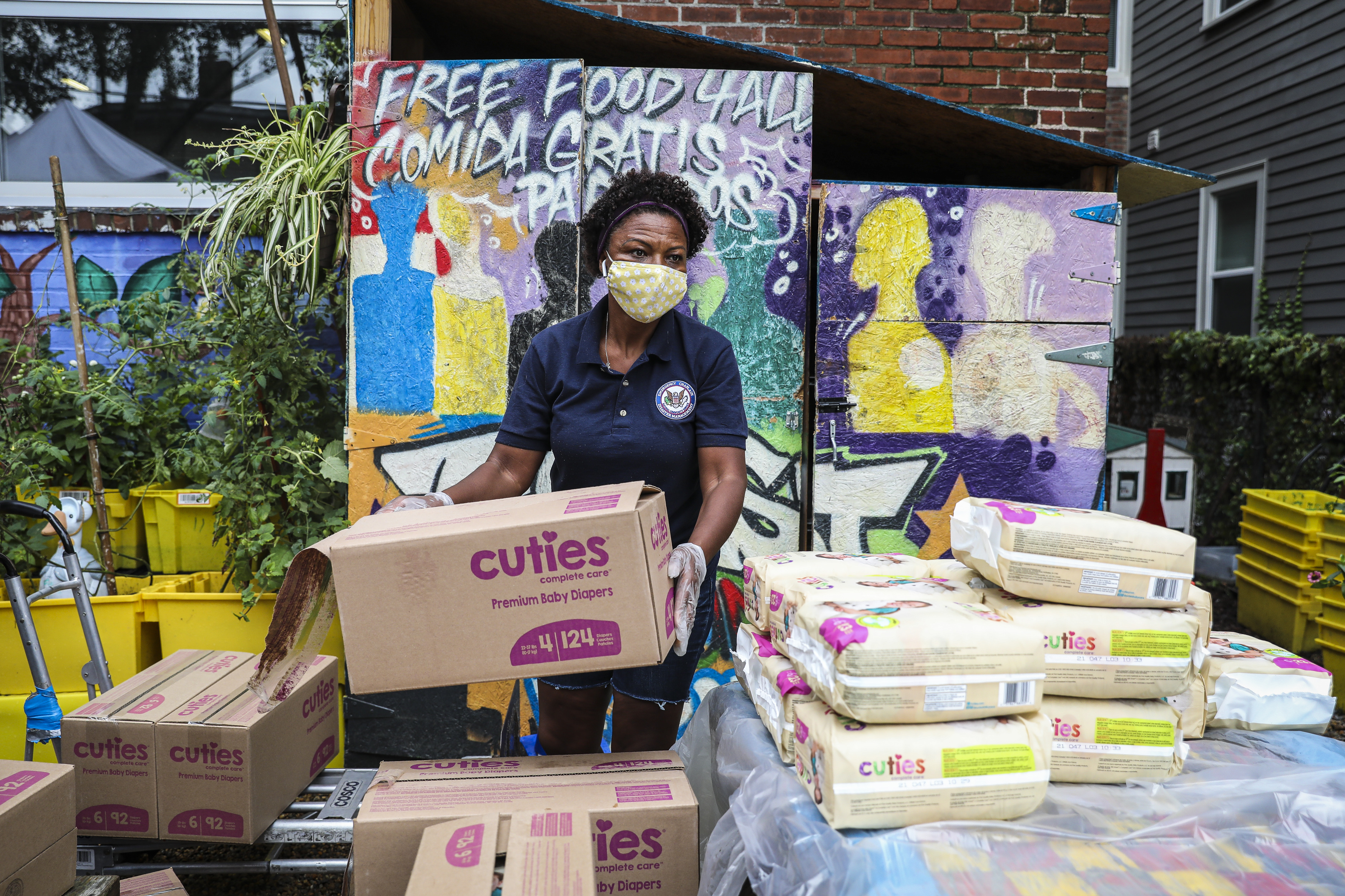 Aparecida Guilherme prepared to hand out diapers at Cambridge Community Center at an event hosted by Cradles to Crayons.