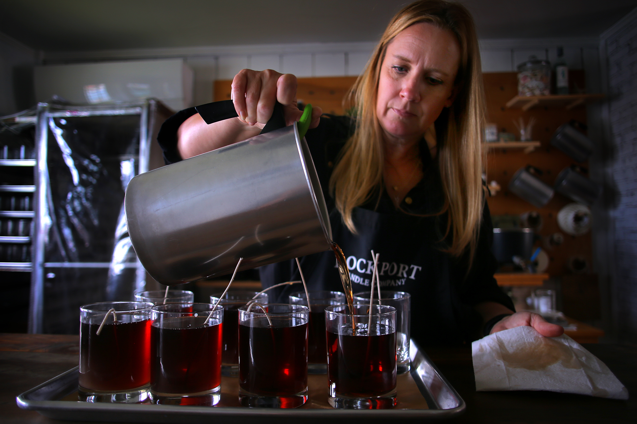 Christina Willcox pours handmade candles at her Rockport Candle Company shop.