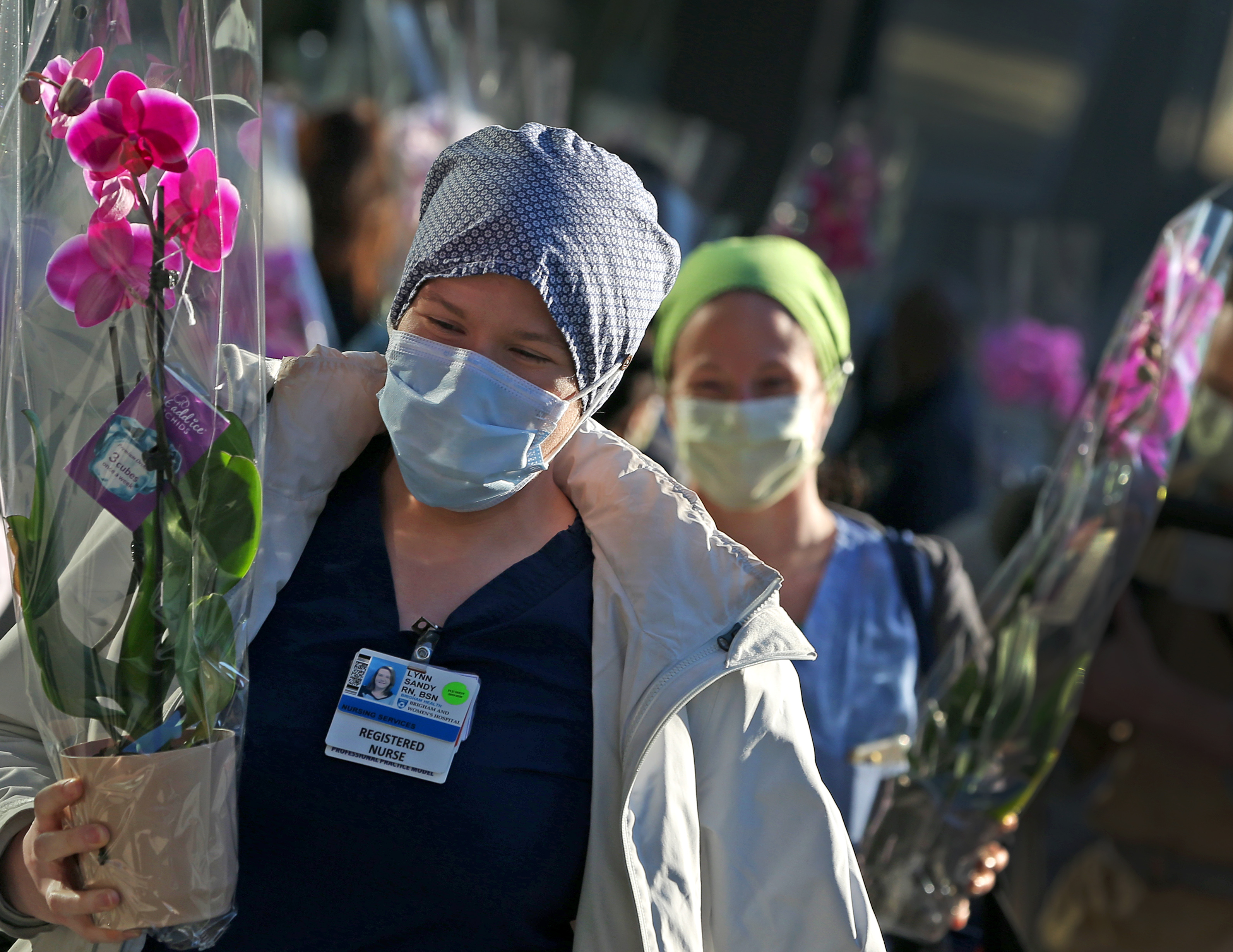 BOSTON, MA - 5/08/2020: As a small gesture of gratitude during National Nurses Week, and in recognition of their tremendous contributions during the COVID-19 pandemic, Brigham and Women’s nurses received orchids outside of the hospital as they exit on Friday morning after working overnight. Hospital leadership distributed the 390 orchids and give nurses a well-deserved round of applause for the dedication and courage they exhibit every day and especially during these trying times. This gift was made possible thanks to Home Depot and ICS Plant Specialists.  (David L Ryan/Globe Staff )