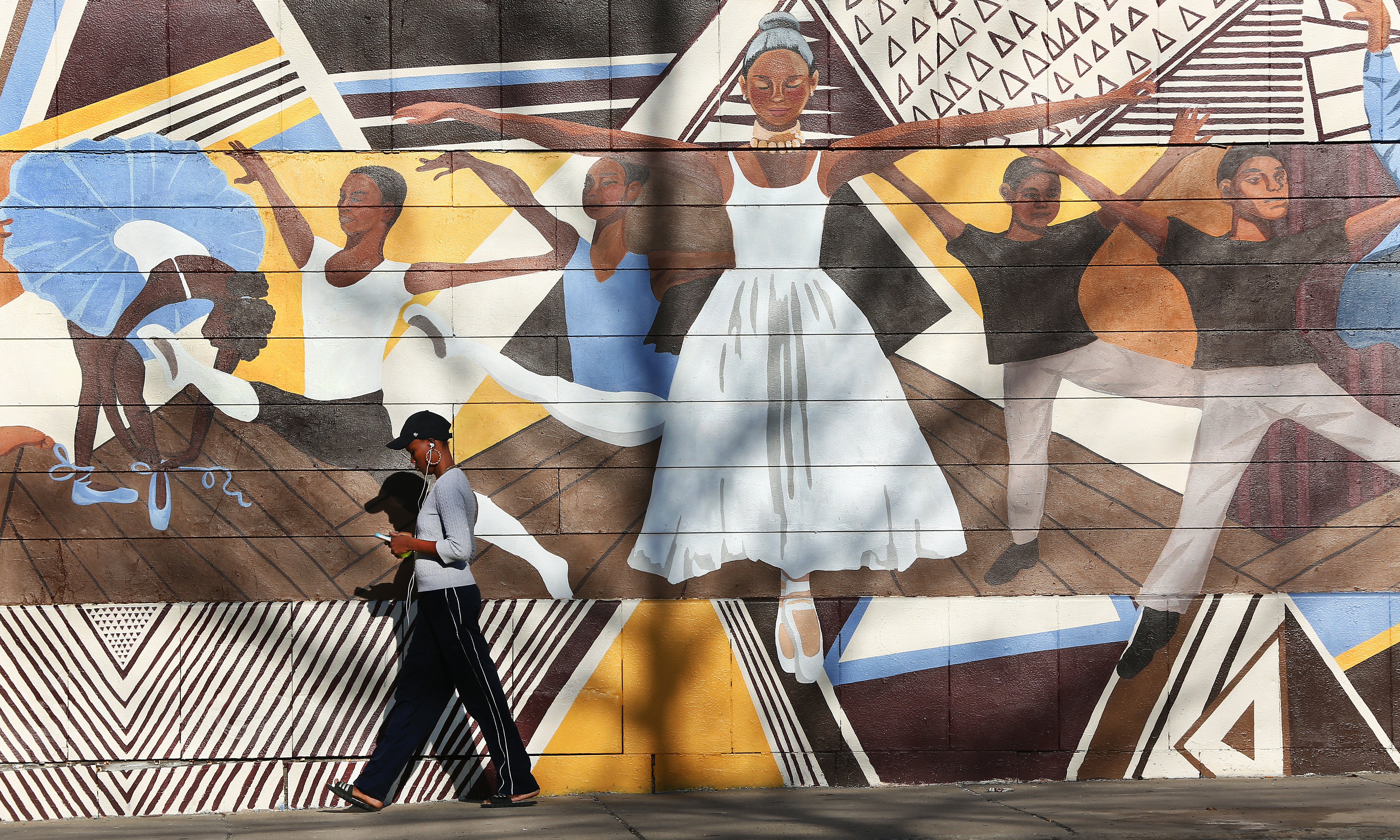 A woman walks by the Roxbury Center for the Performing Arts, on Blue Hill Avenue in Dorchester in 2017.