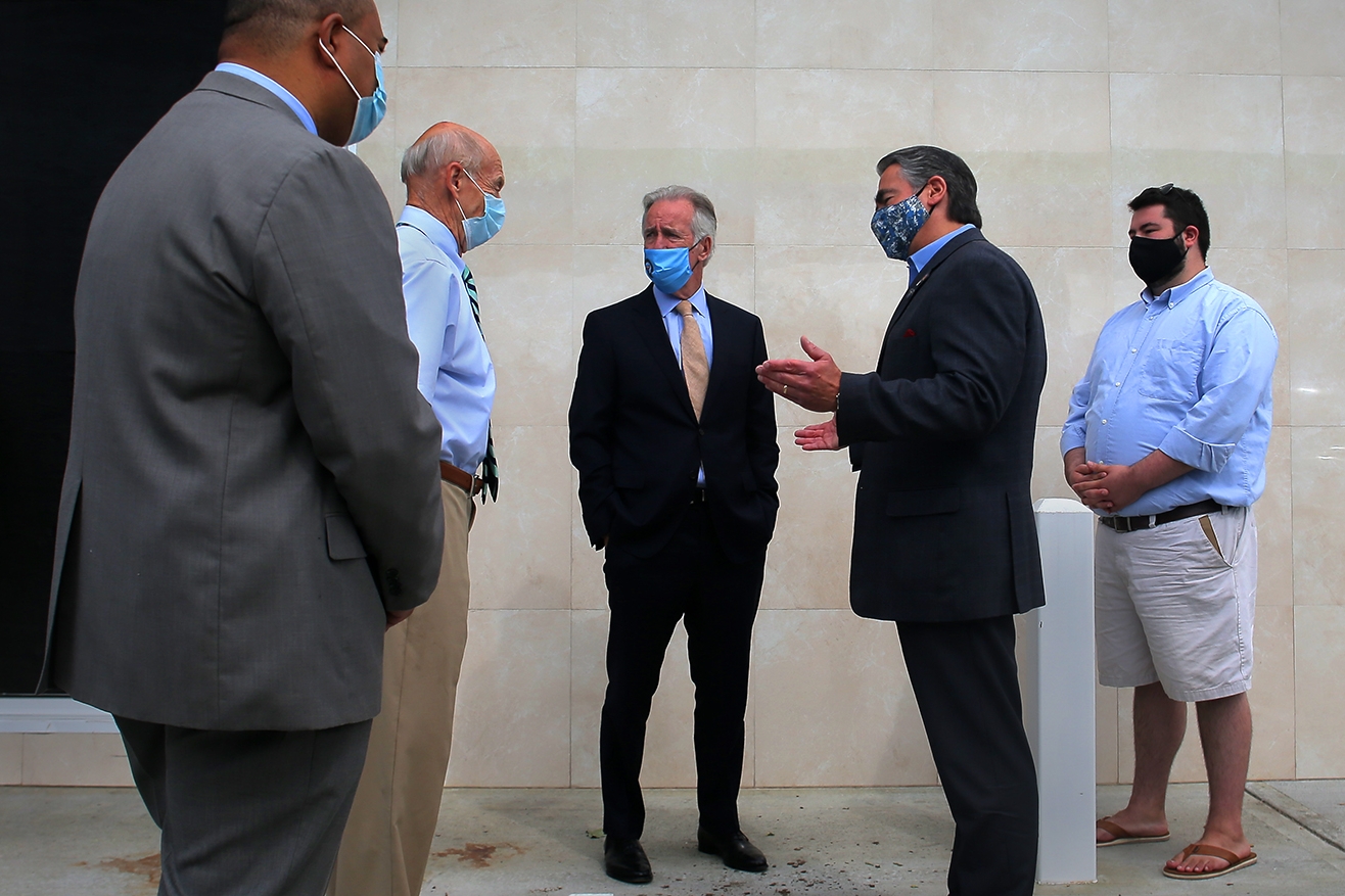 Congressman Richard Neal (center) spoke with Springfield Mayor Domenic Sarno at a ribbon-cutting ceremony at a gas station convenience store opening on State Street.