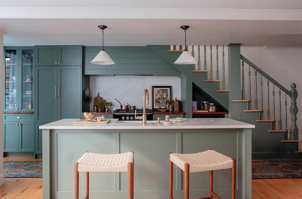 An on-trend kitchen painted green, including the island.