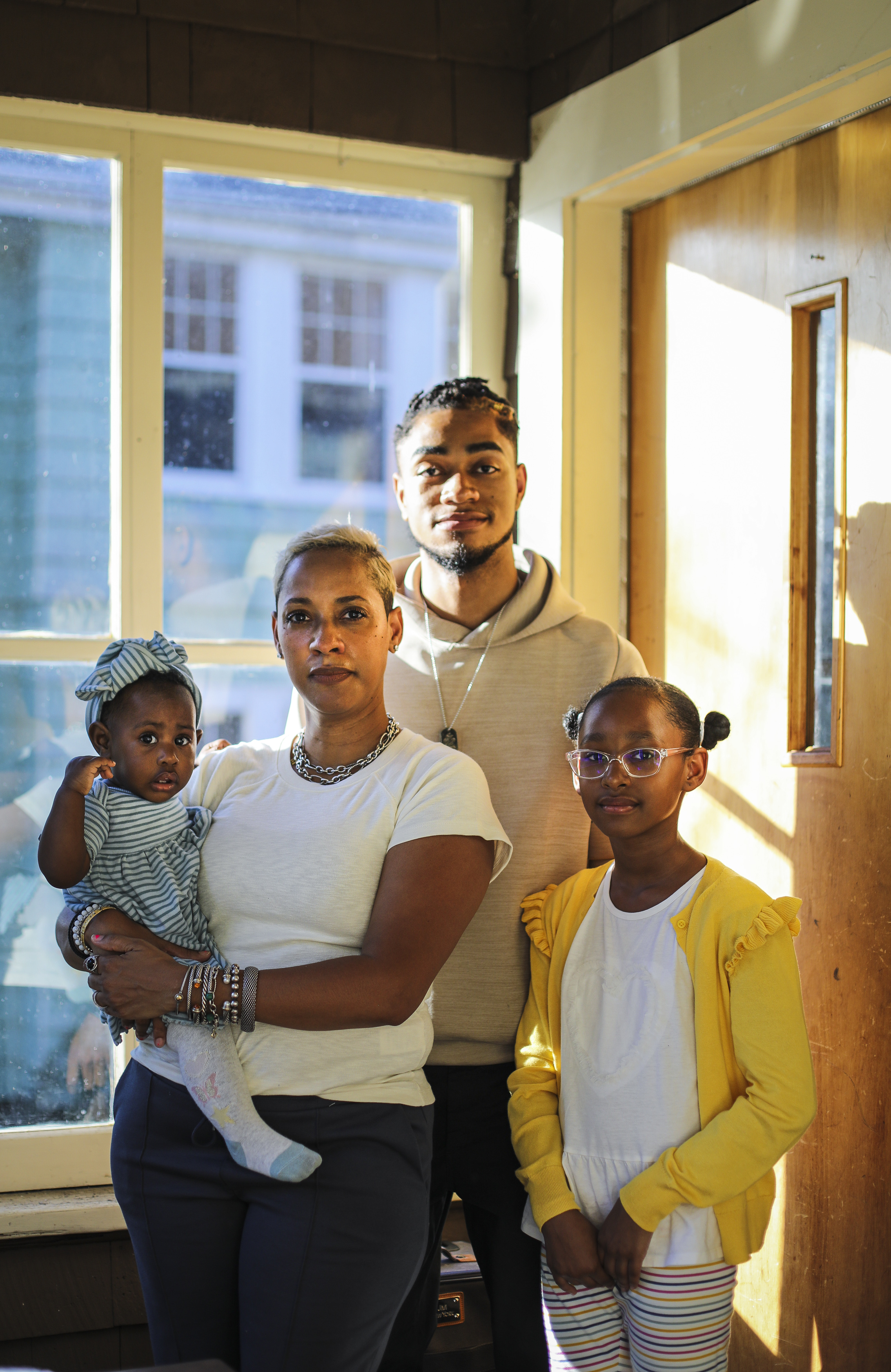 Doula She-Tara Smith and her 10-month-old daughter, Cheyenne, son Avari Price, and daughter Landyn at home in Newton.