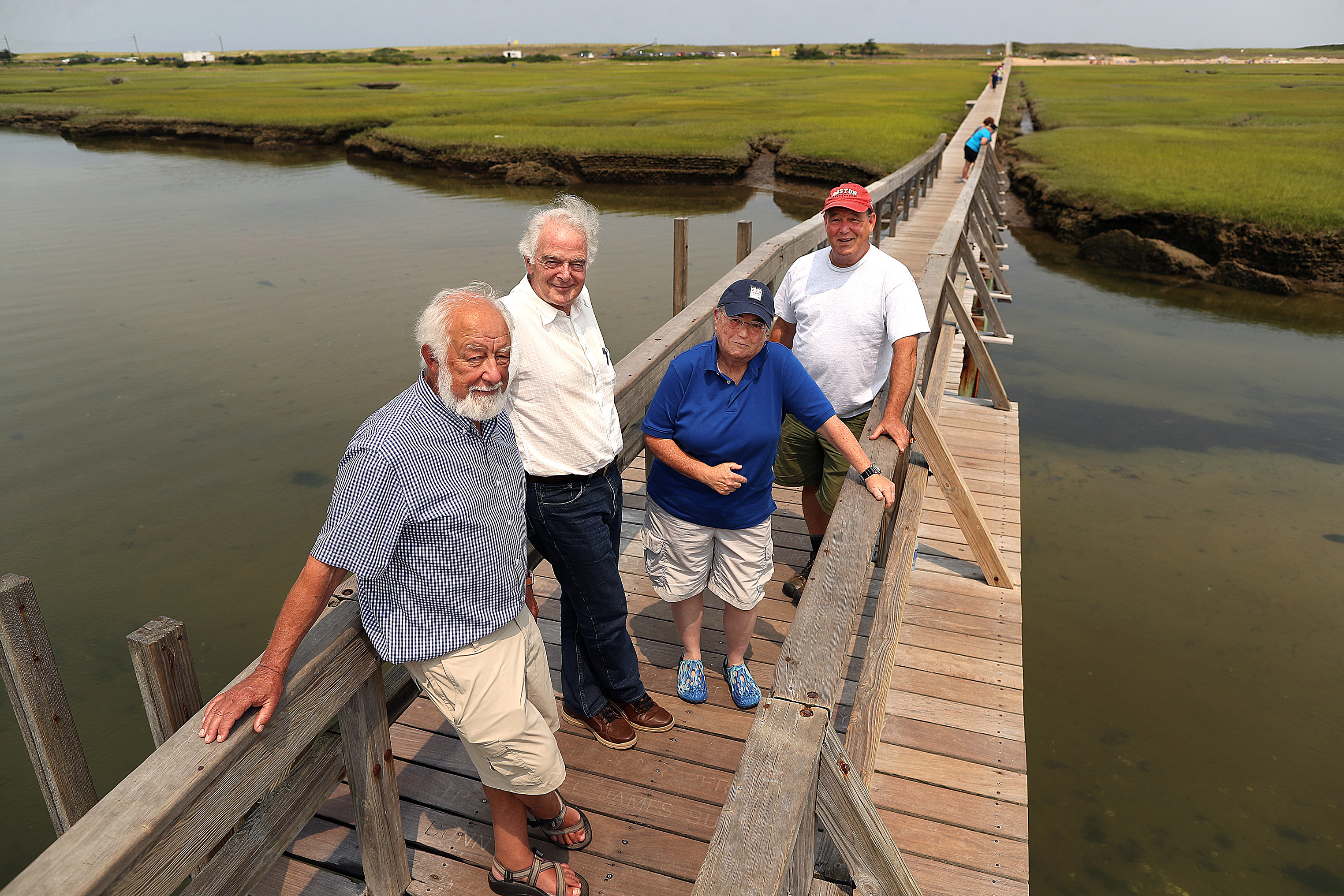 Sandwich boardwalk preservationists, left to right, Dean Coe, Jon Fitch, Candy Thomson, and Peter Thomas stood on the boardwalk that is slated to be replaced.