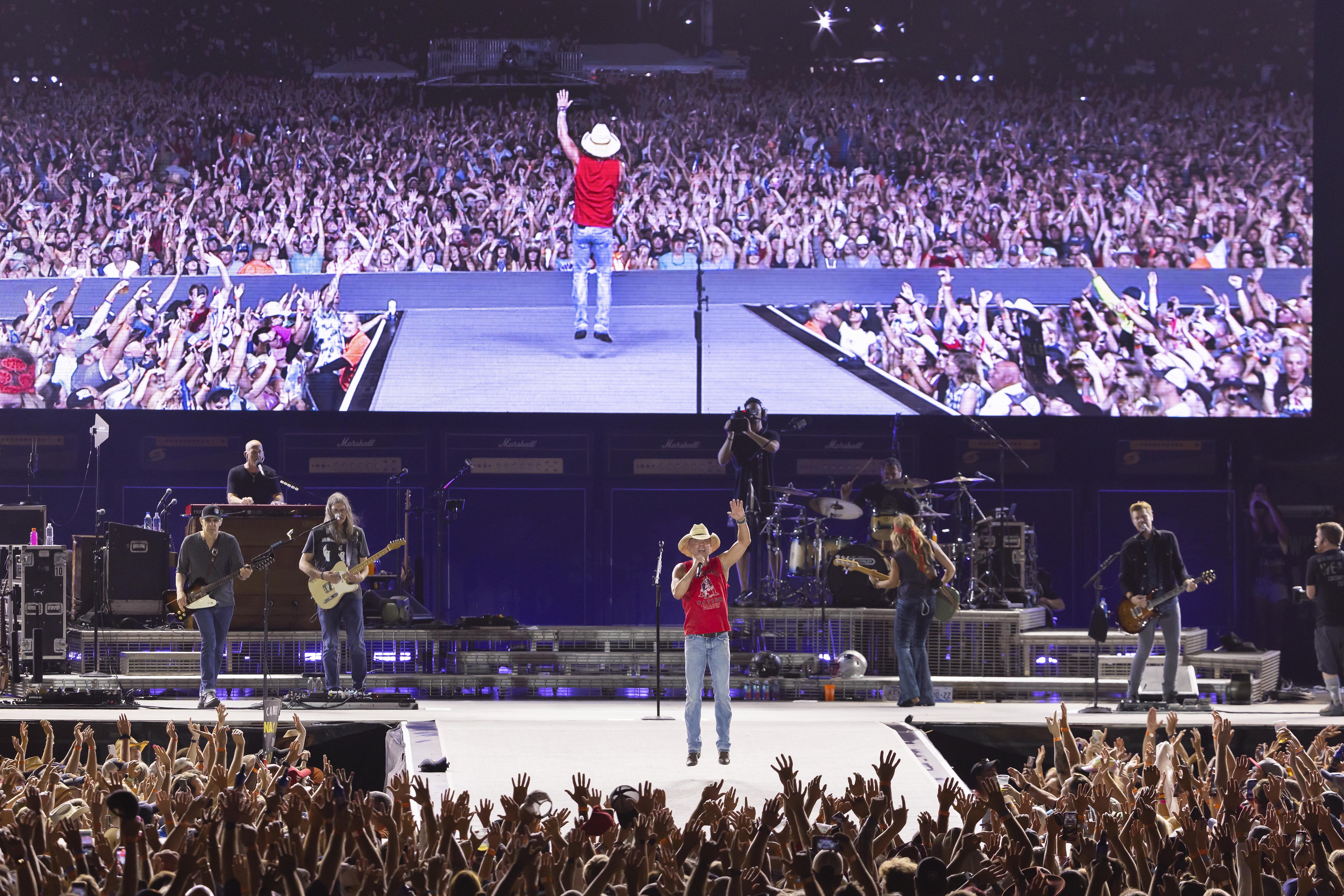 Robert and Jonathan Kraft on stage with Kenny Chesney at his Gillette  Stadium concert