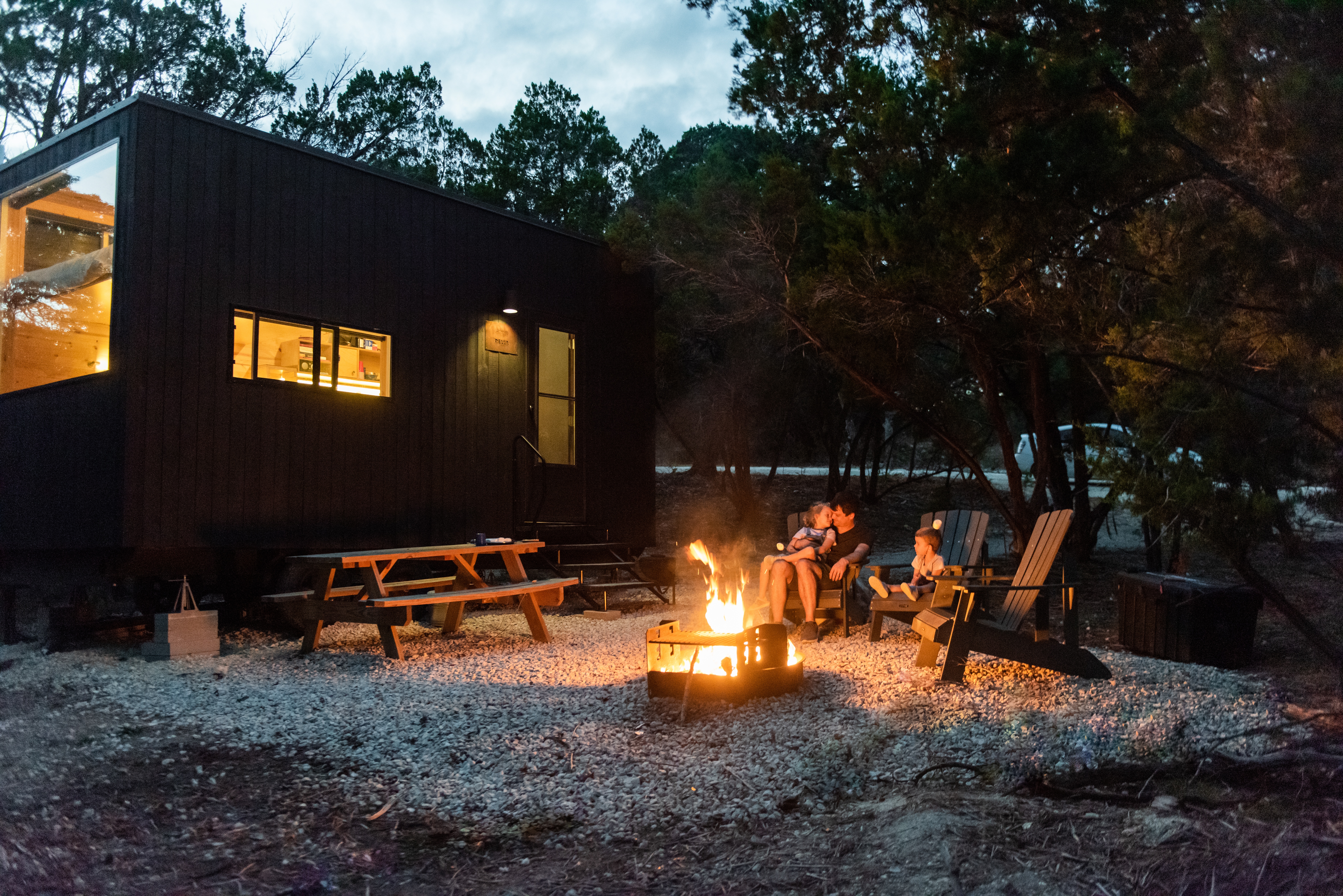 A family enjoys the fire pit outside a Getaway House.