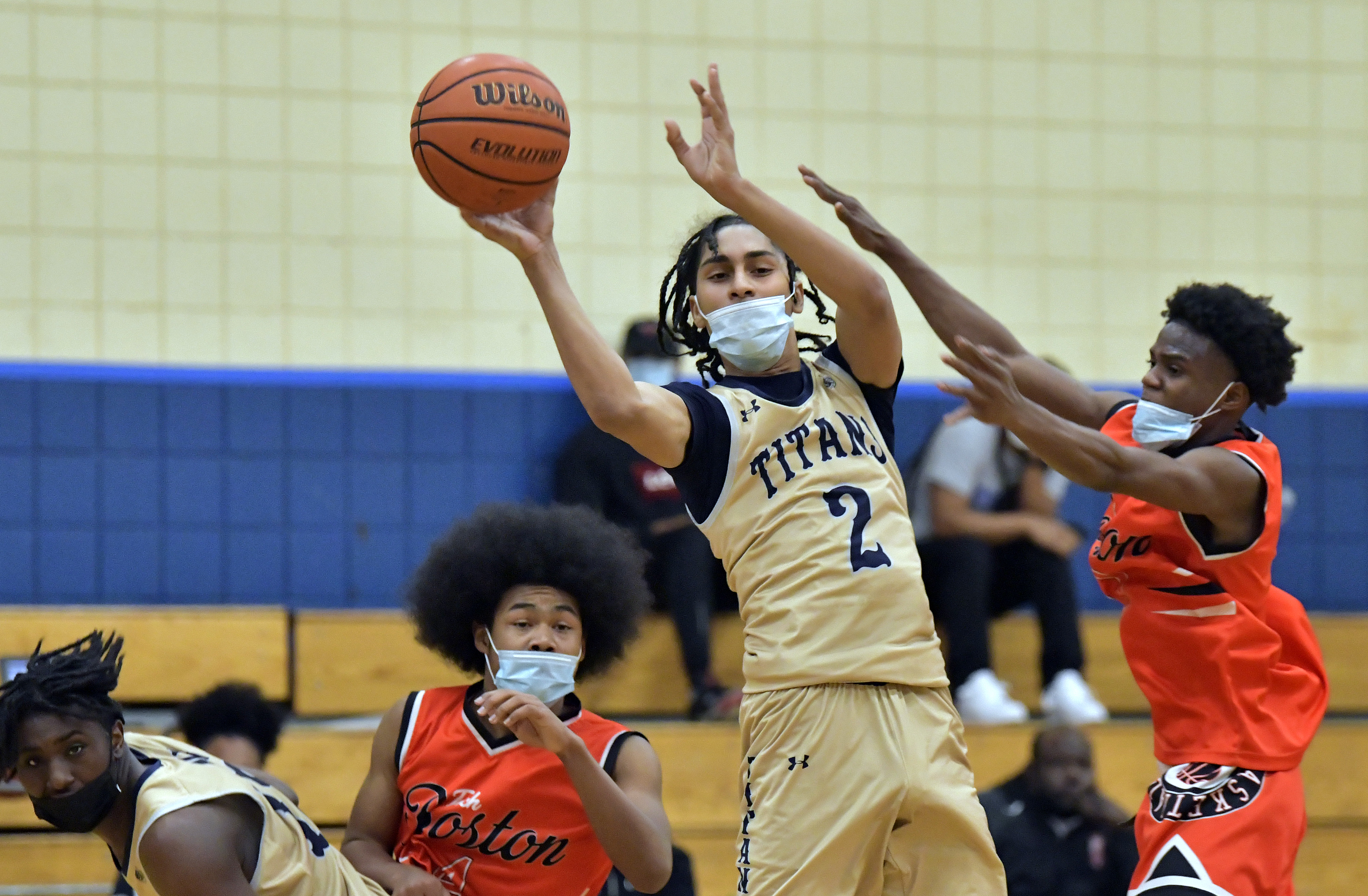 New Mission's Juan Salas slices between a pair of TechBoston defenders to make a pass during Friday night's game.