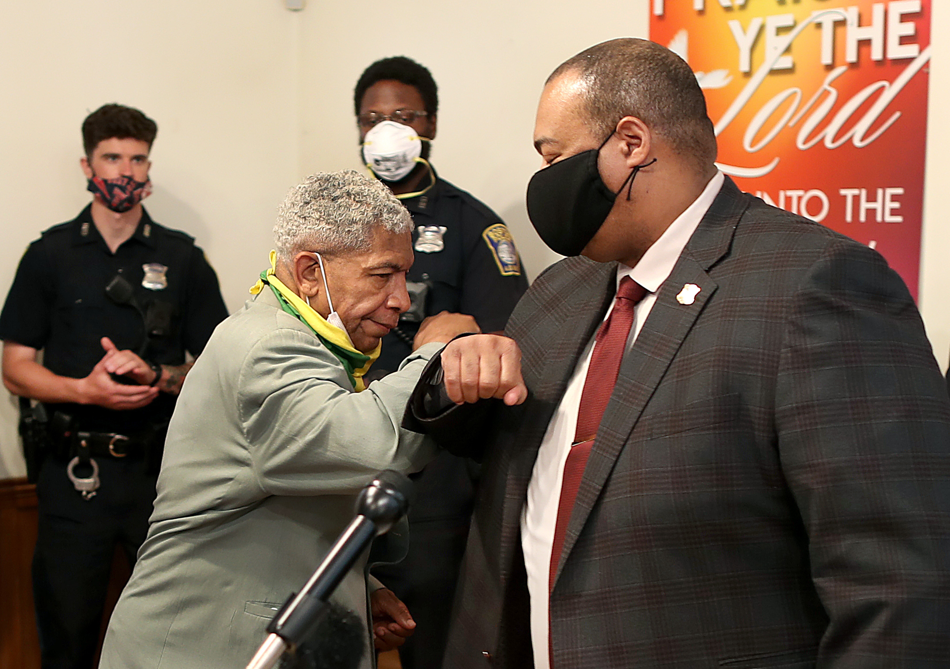 William Gross (right) bumped arms with Rev Eugene Rivers (left) before Gross spoke at the Ella J. Baker House in Dorchester where Black pastors stood in solidarity with the Boston Police with regards to the recent protests and riots on June 3, 2020.