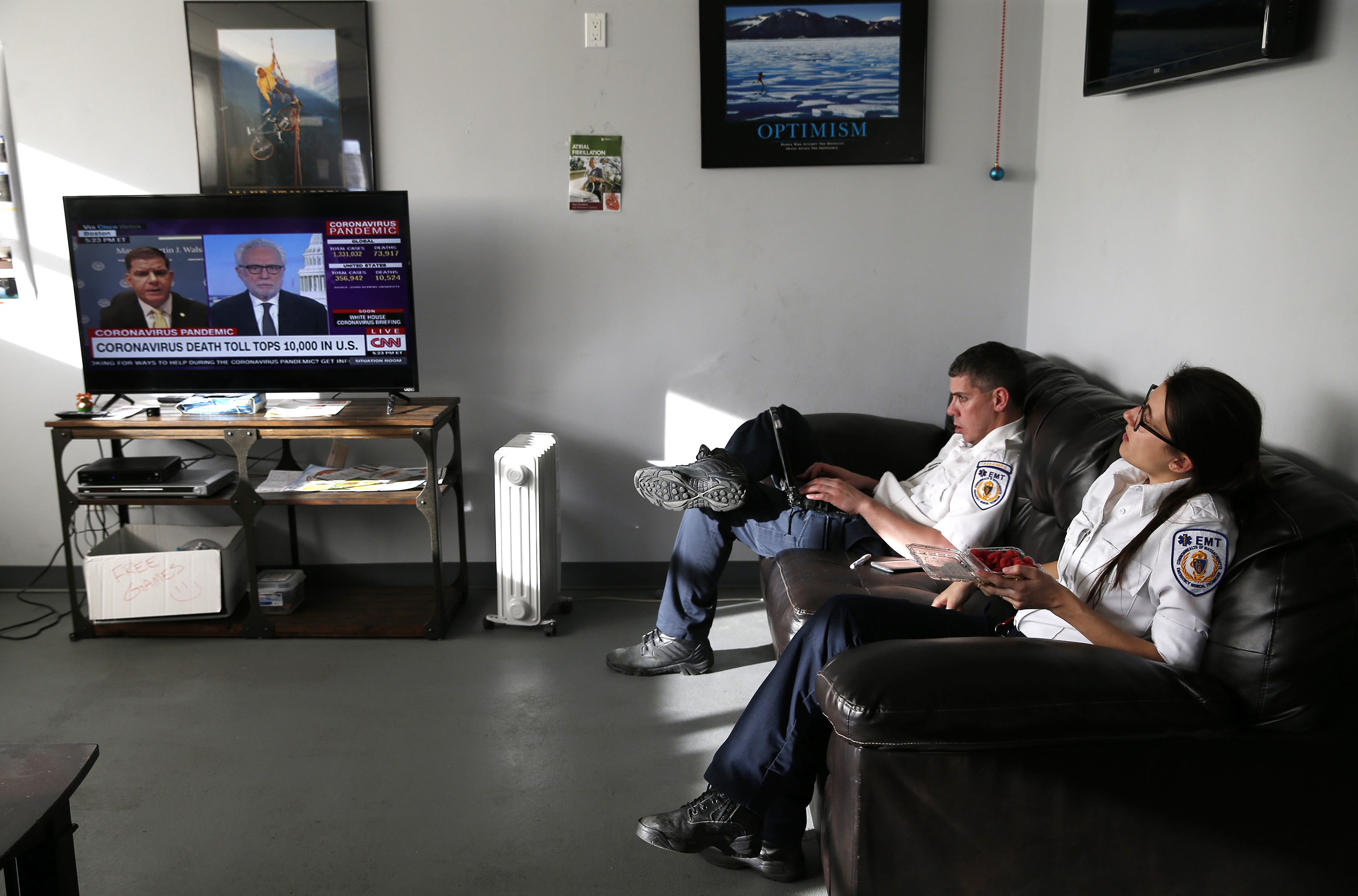 Monday, 5:23 p.m. During a break between calls, Emily found time for a quick snack and Ricky filled out reports on his computer as Boston Mayor Martin J. Walsh was interviewed live on CNN about Boston’s response to the coronavirus.