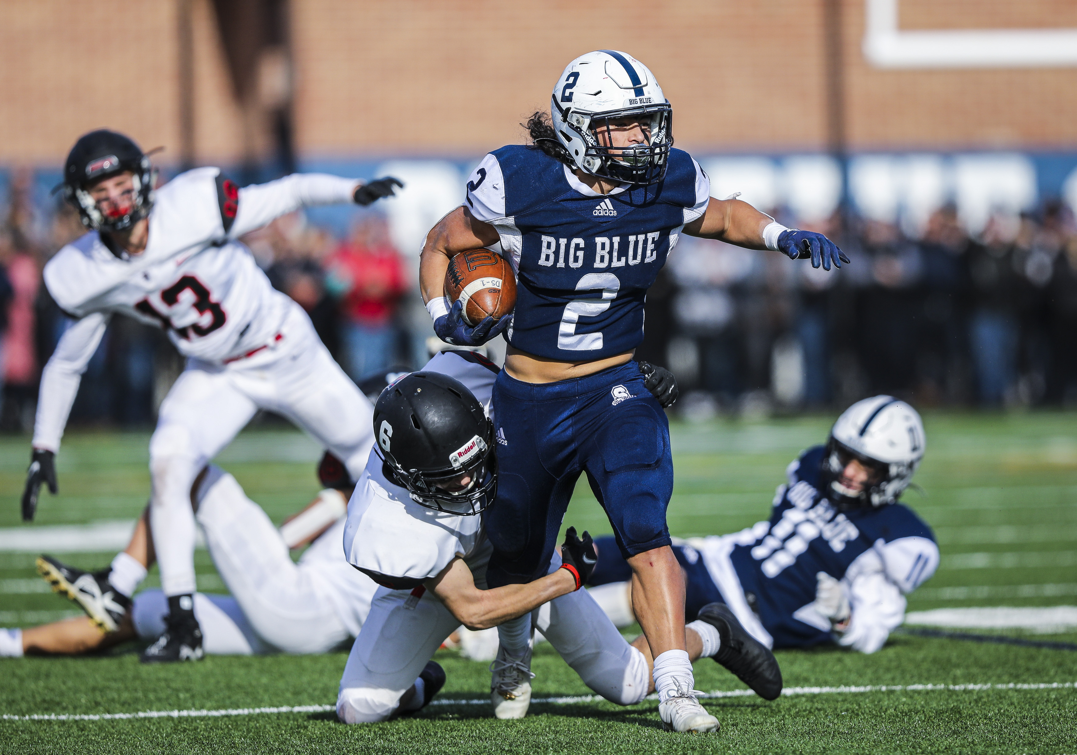 Swampscott’s Xaviah Bascon (2) tries to shake a tackle attempt by Marblehead's Andy Palmer.
