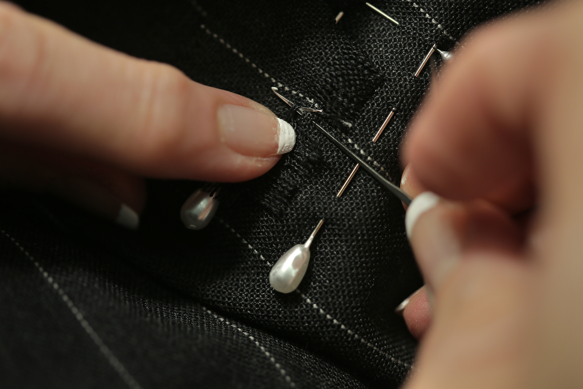 Toni Columbo pins her repairs into place.