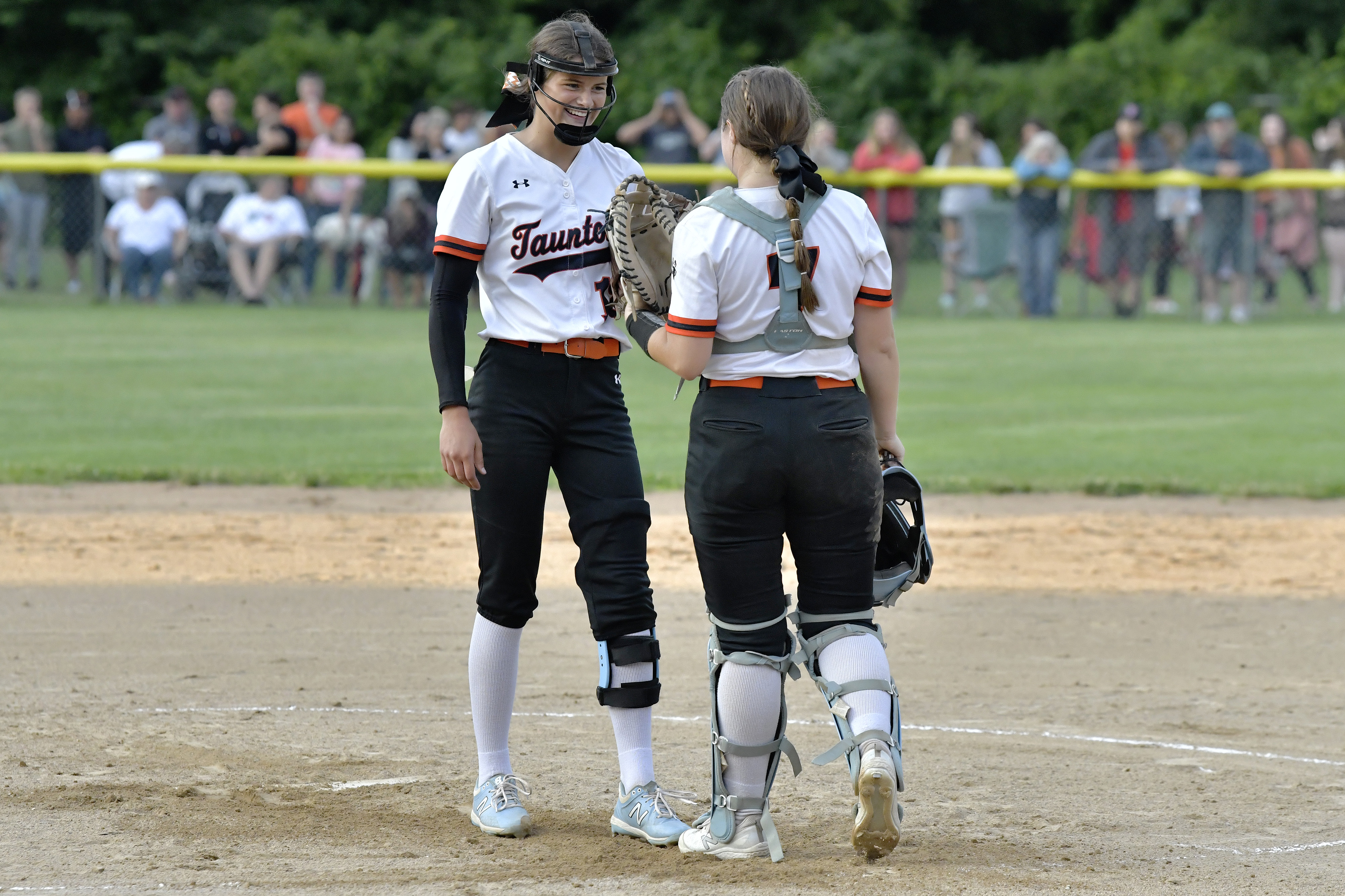 Fans lined the outfield fence to watch pitcher Kelsey White, catcher McKenzie McAloon, and the Taunton High softball team in the state final.