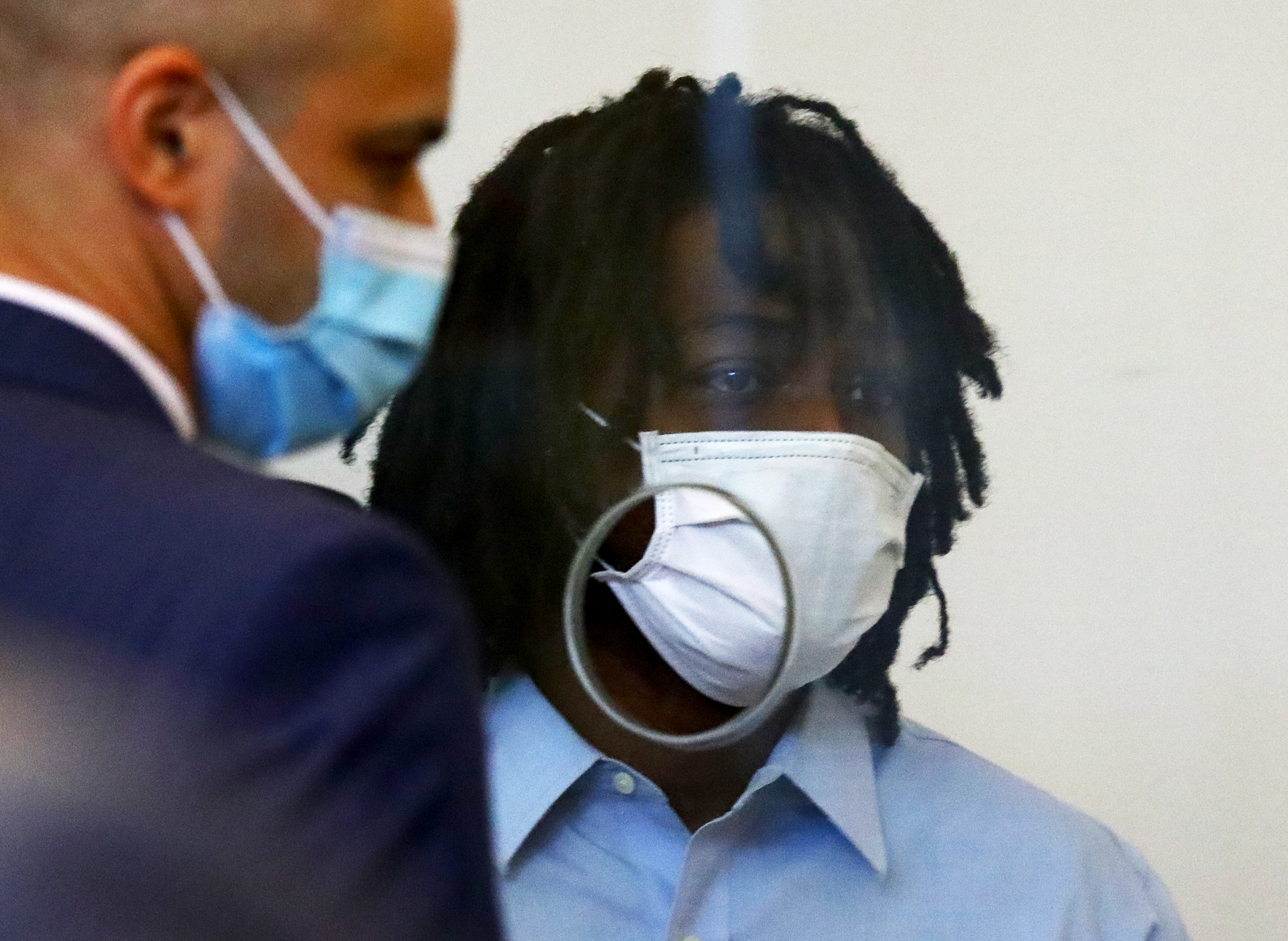 Marcus Chavis is led from the prisoner’s dock after his arraignment in Dorchester Municipal Court on two counts of murder and one of animal cruelty.