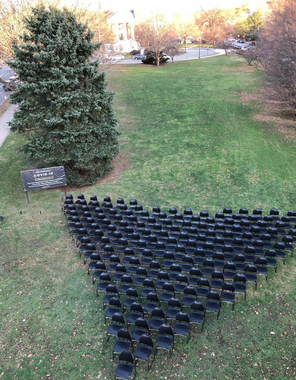 Rows of chairs outside Newton City Hall lawn to commemorate Newton residents who have died due to COVID-19.