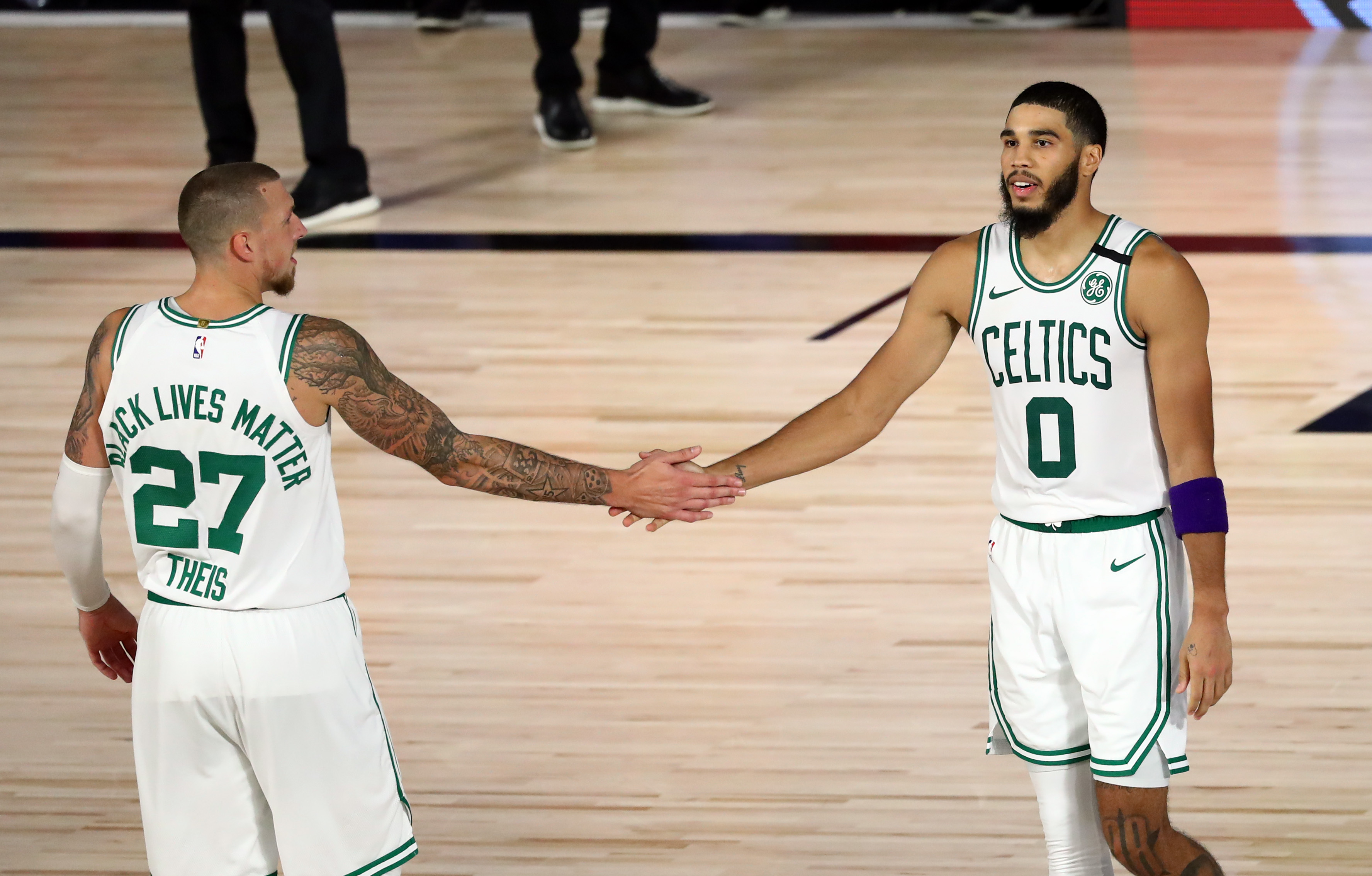 Jayson Tatum celebrates with Daniel Theis during the fourth quarter of Sunday's Game 4.