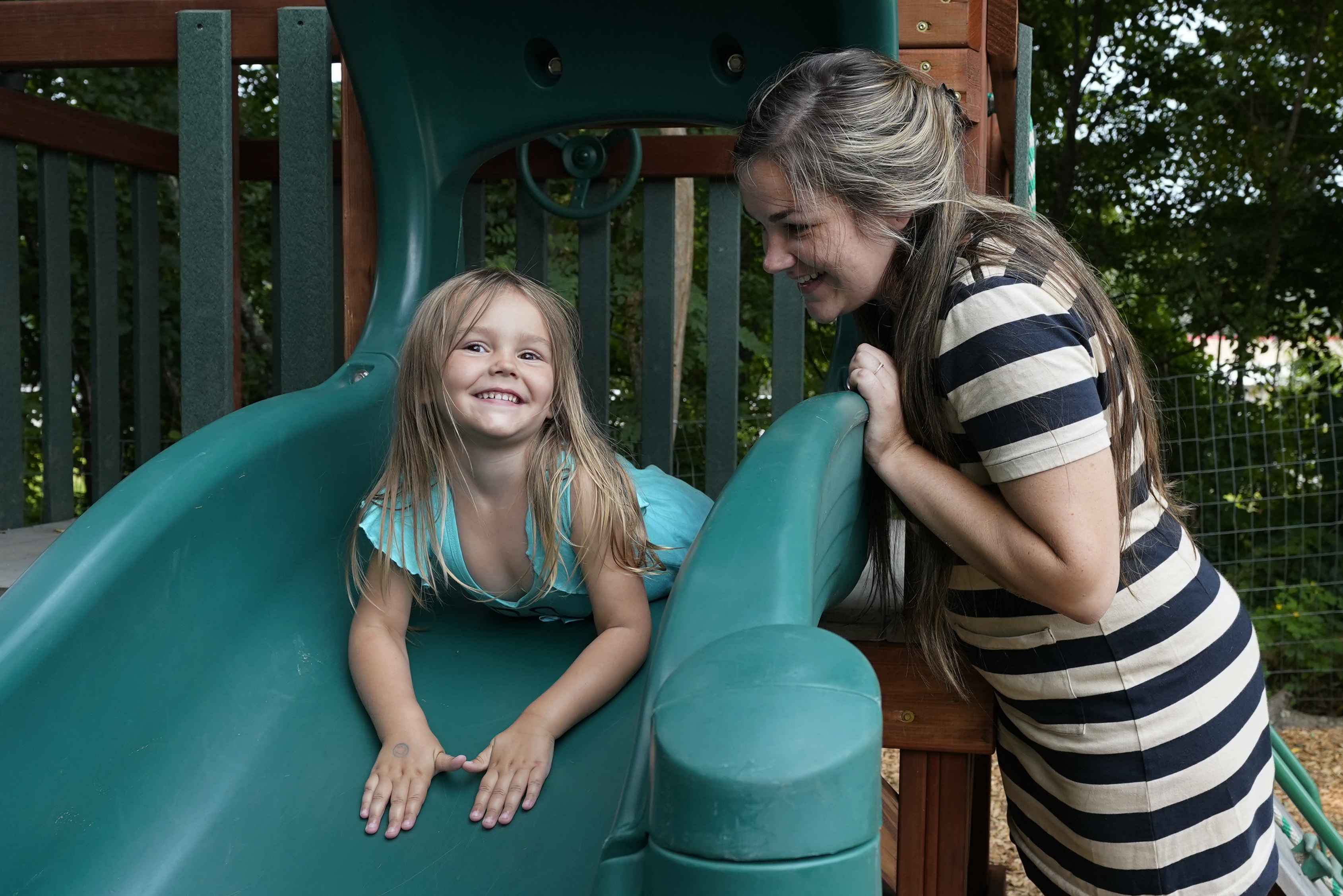 Brianne Walker plays with her 3-year-old daughter, Jeannette, at A Place To Grow daycare in Brentwood, N.H., July 26. Walker and her family have qualified for the expanded child tax credit, part of President Joe Biden's $1.9 trillion coronavirus relief package. "The additional money does help alleviate the pressure," said Walker, 29, who took custody of her two siblings last year after her mother overdosed. The $800 credit will help make up for losses she incurred after quitting a kitchen-design job to care for her three children, as well as her two younger brothers.