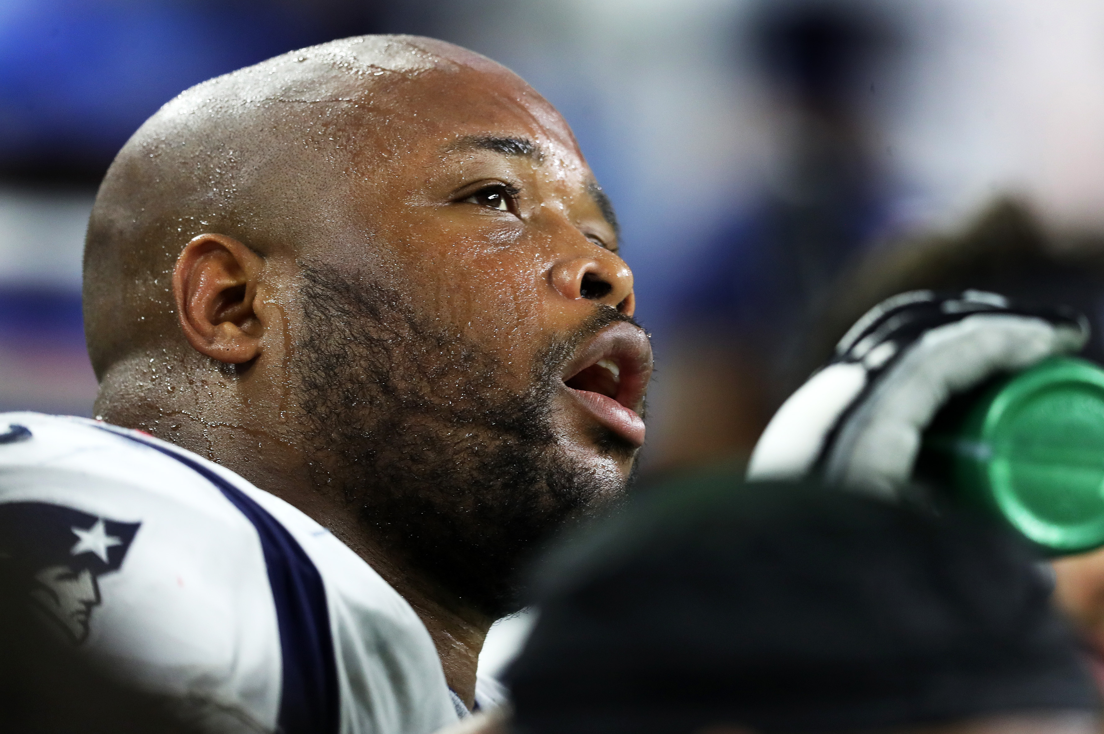 Marcus Cannon hydrates on the bench late in a 2019 game against Houston.