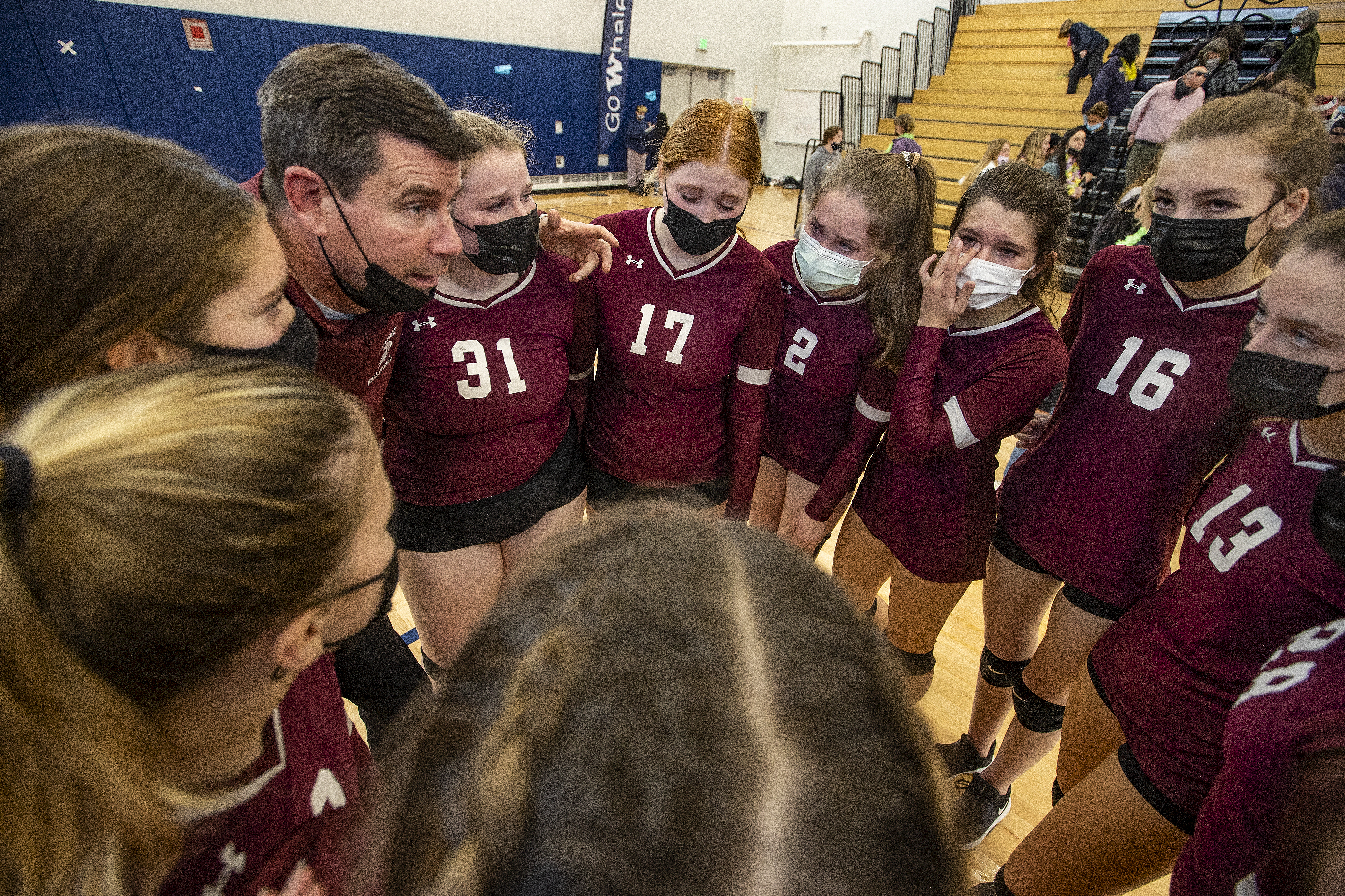 Coach Kyle Henry consoles his players after a tough loss.