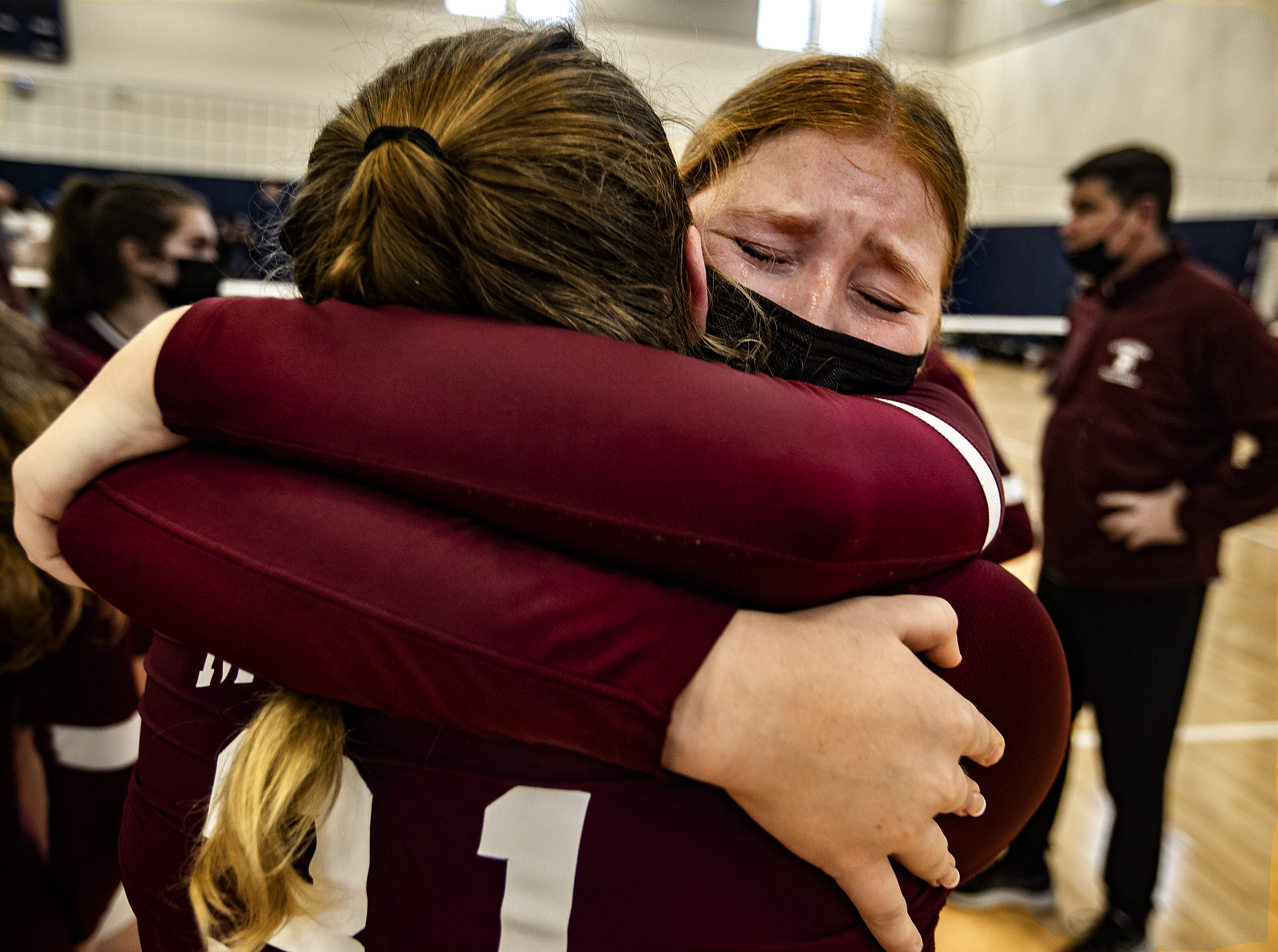 Mia Wade hugs a teammate after the heartbreaking loss.