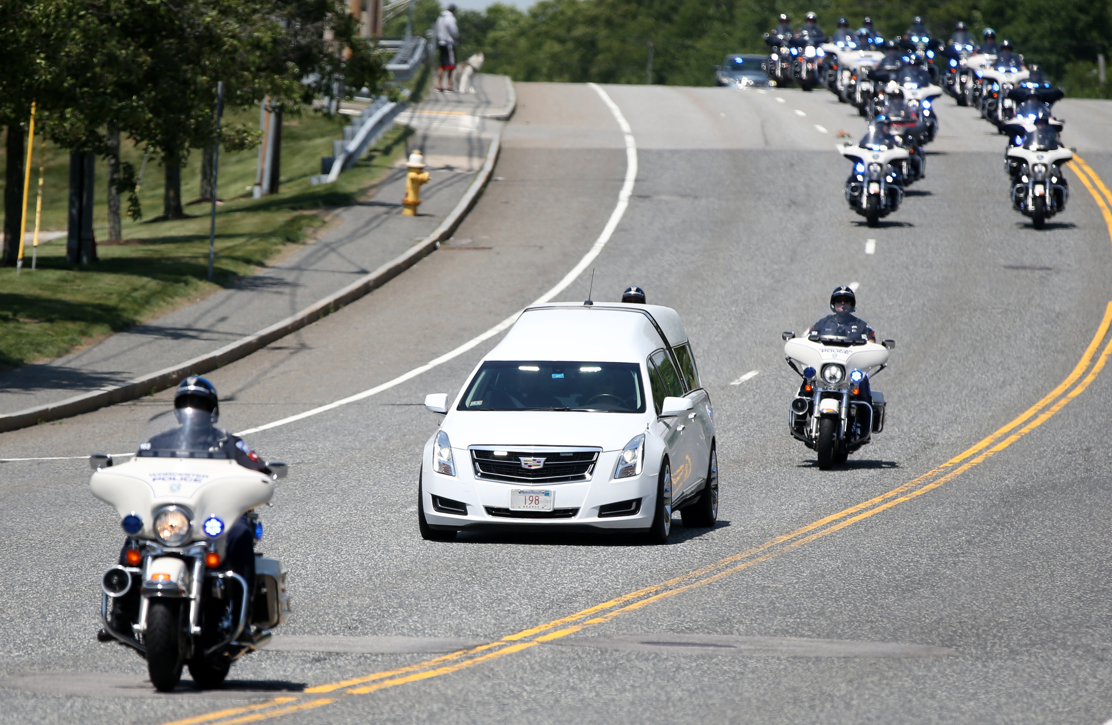 The procession escorting the body of Worcester Police officer Enmanuel Familia makes its way to the Mercadante Funeral Home & Chapel Saturday.