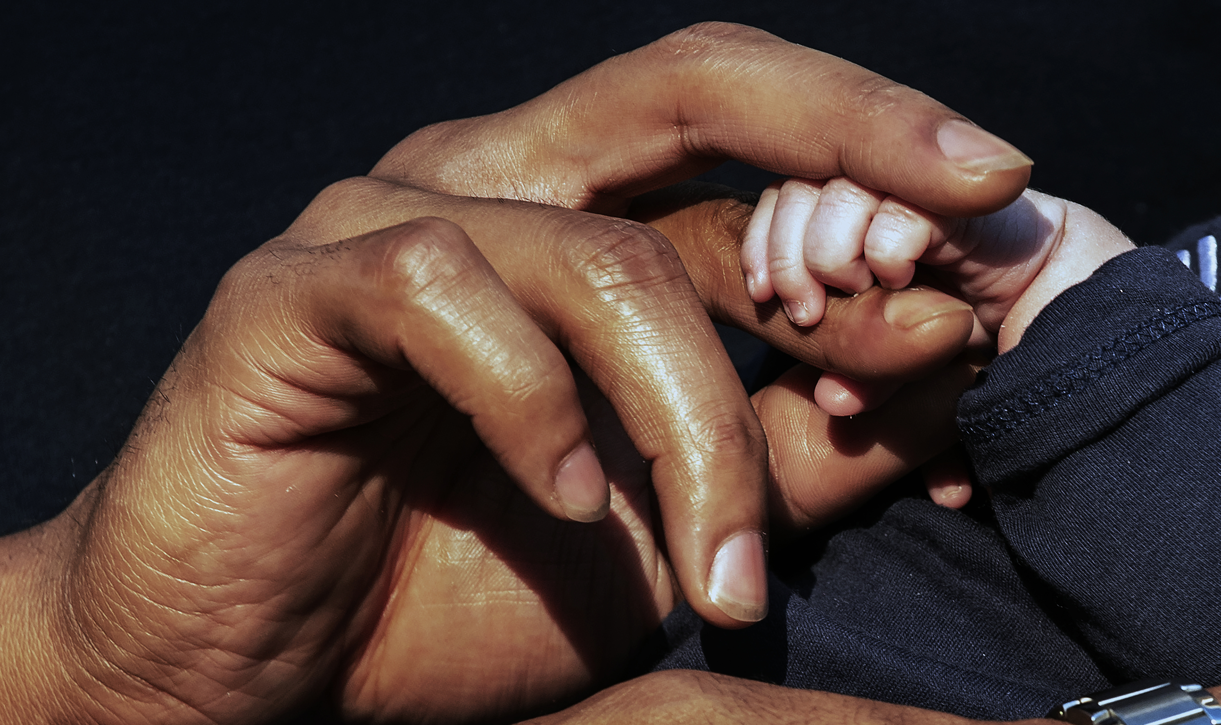 Dont'a Hightower held his son Grayson's fingers.