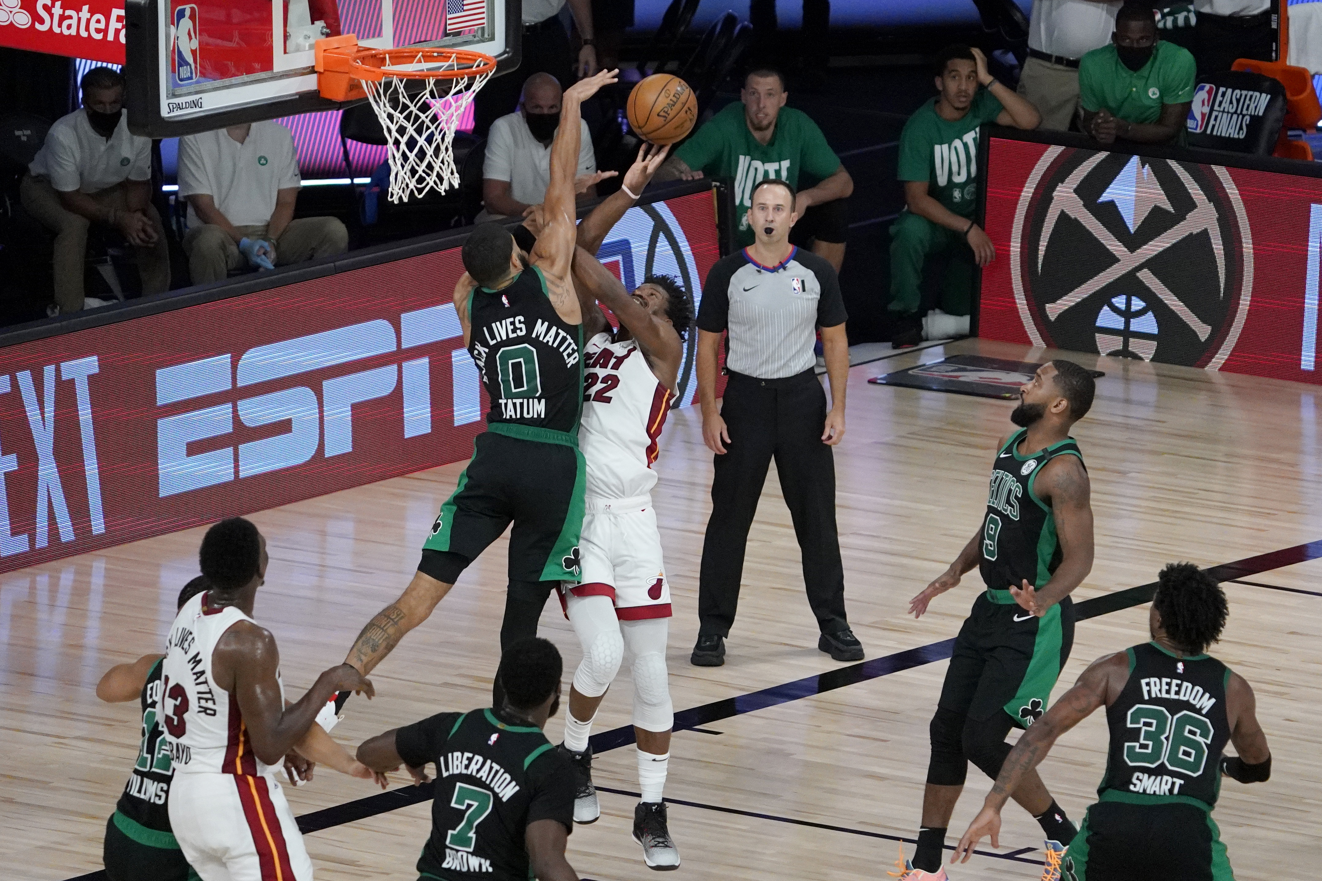 Jayson Tatum defends a shot by Jimmy Butler during overtime of Tuesday's game.