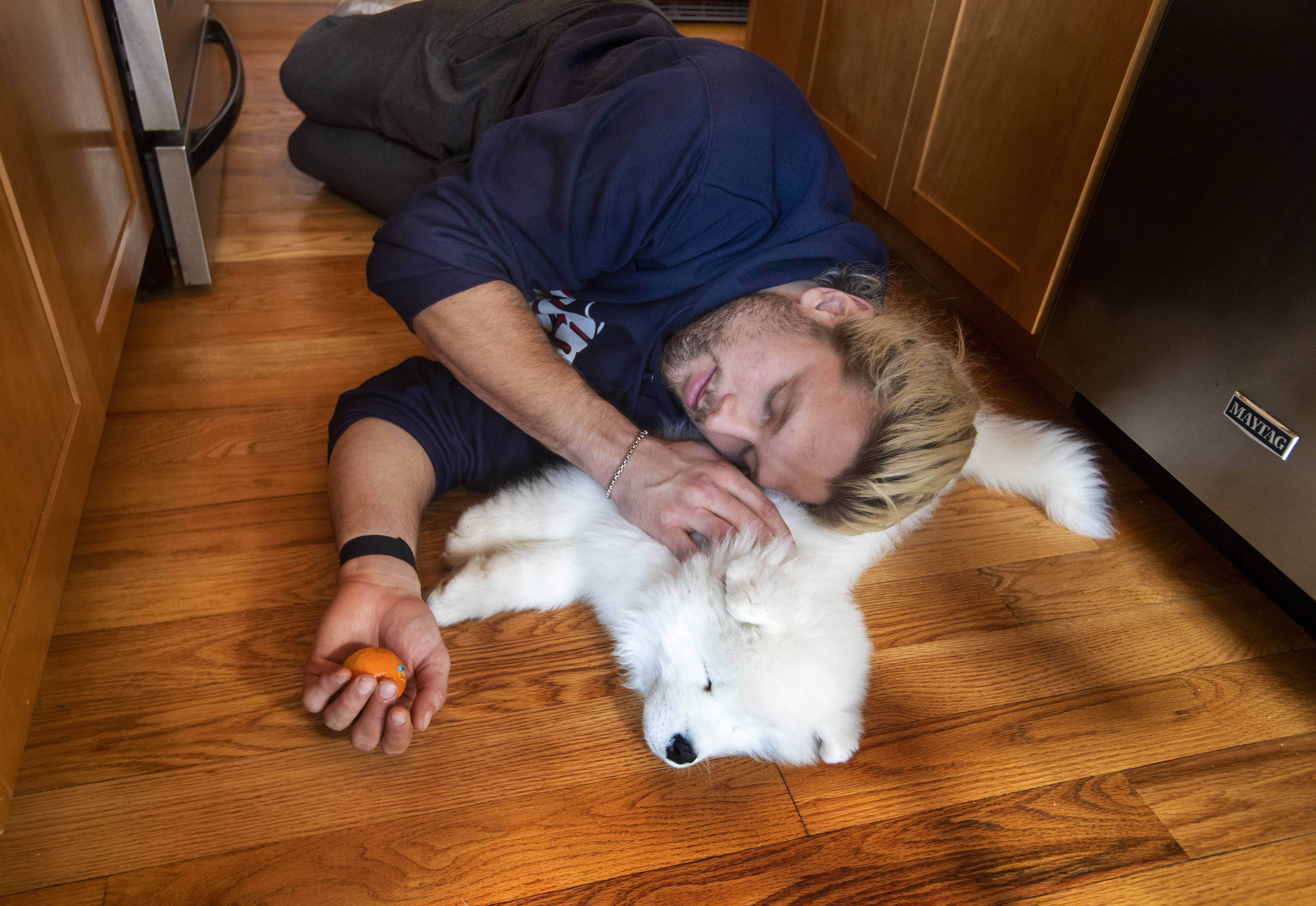 Chase Winovich cuddles with Zeus, his Samoyed puppy.
