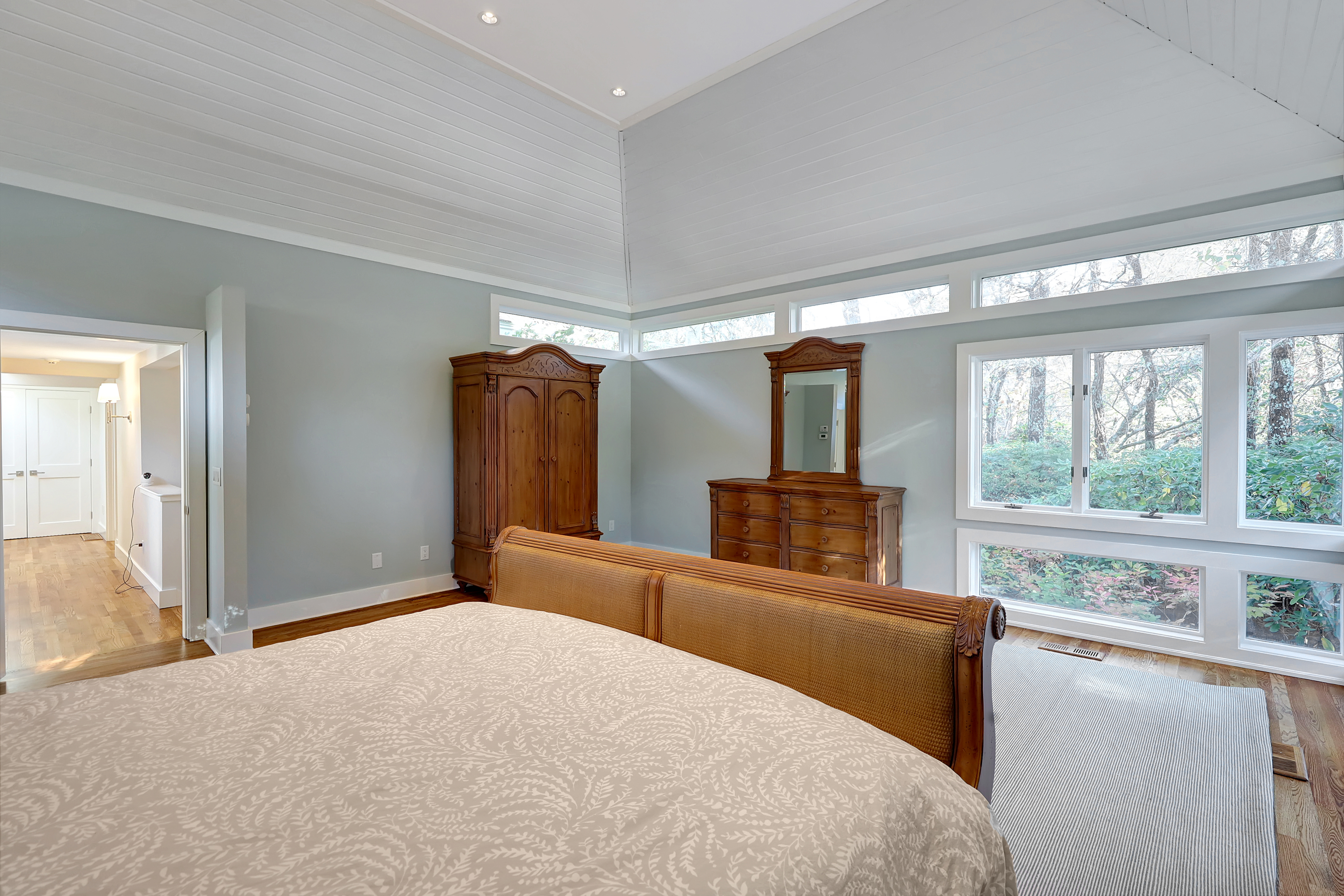 The bedroom in the guest quarters has a cove ceiling with recessed lighting.