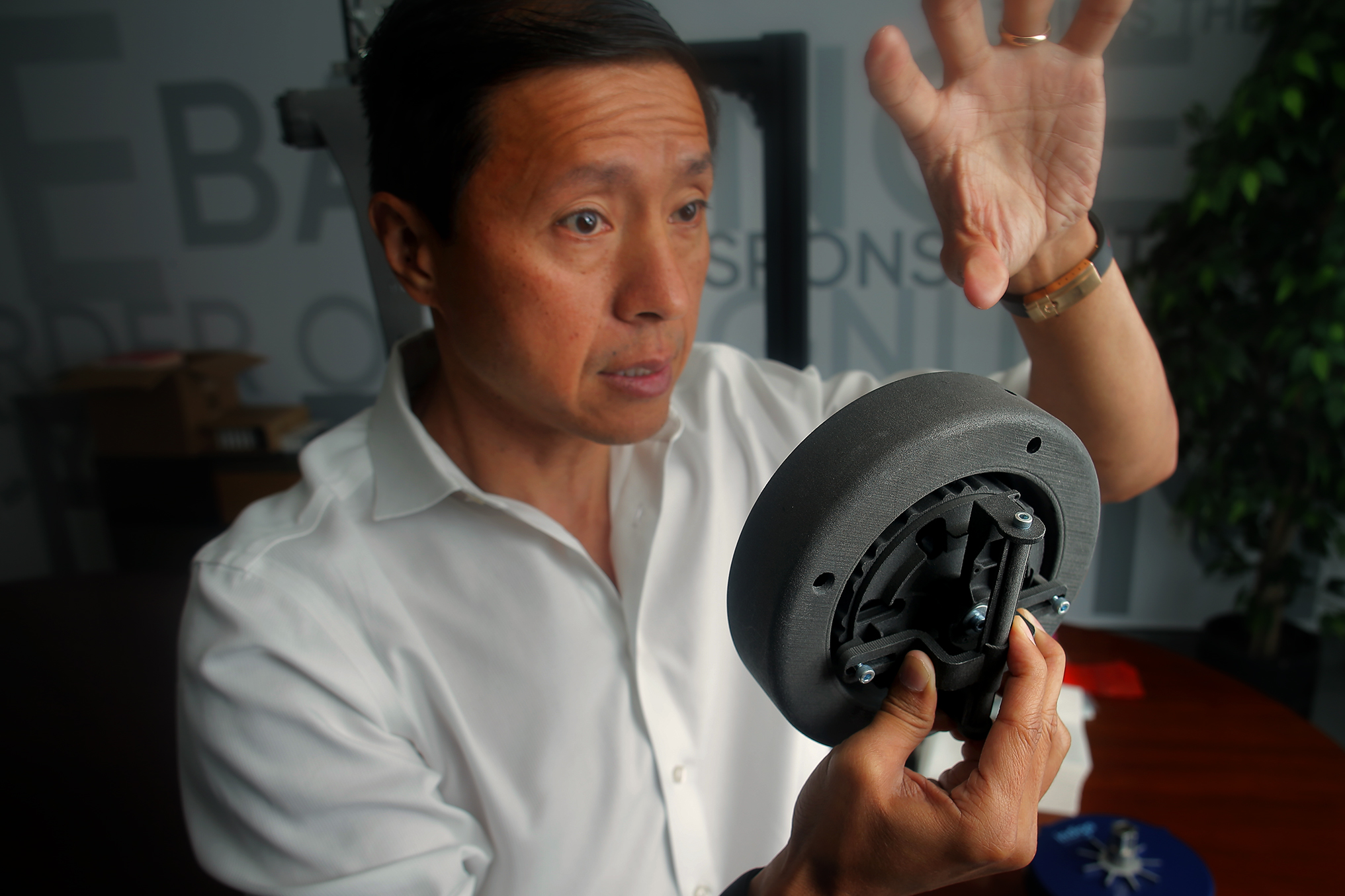 Indigo CEO Will Graylin shows a model of the motorized wheel.