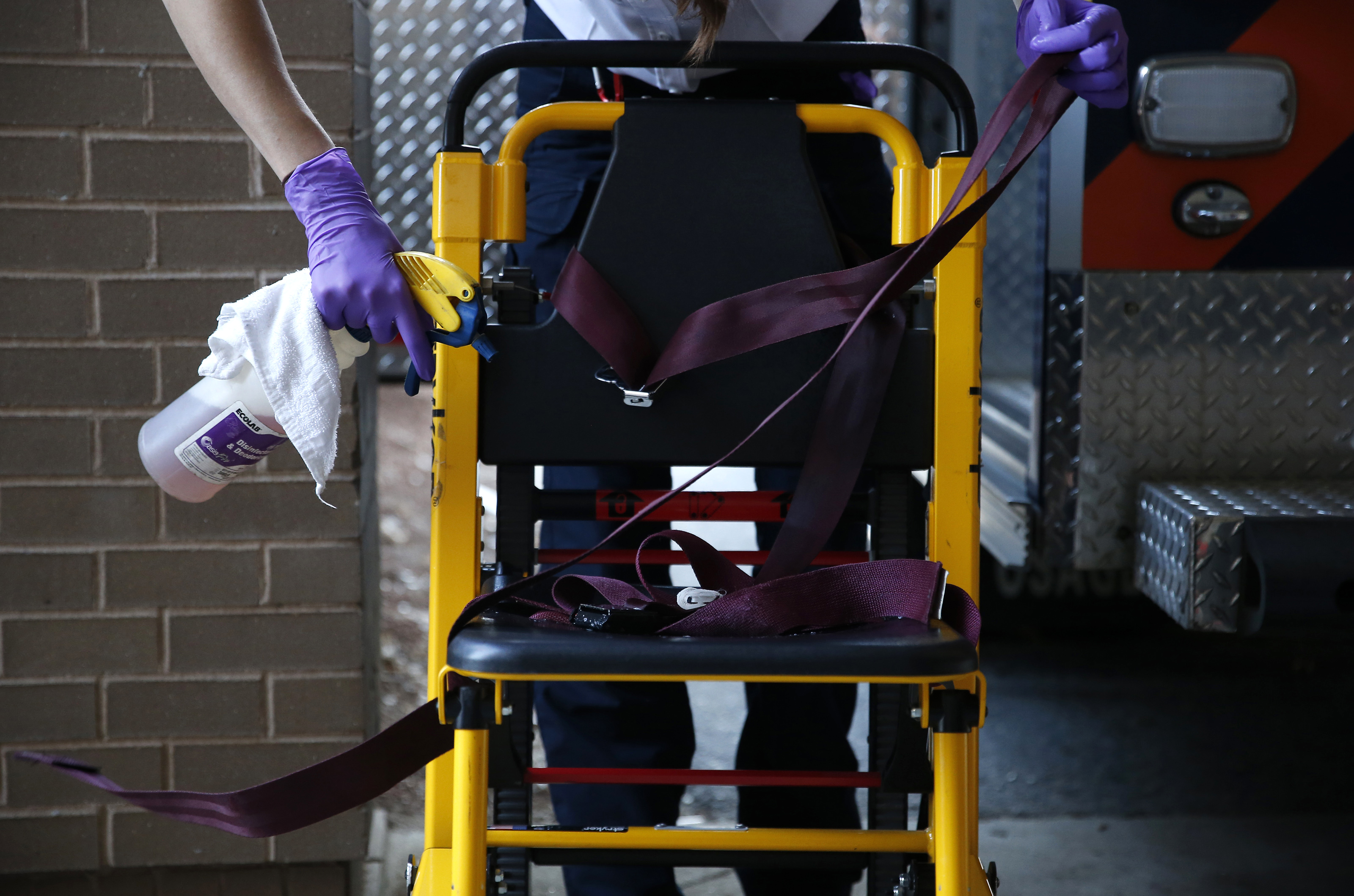 Monday, 6:04 p.m. After helping to take a patient into the Melrose Wakefield Hospital Emergency Room, Emily returned to clean off every item that was used on the call. She sprayed disinfectant on a stair chair that was used to move the patient out of his home.