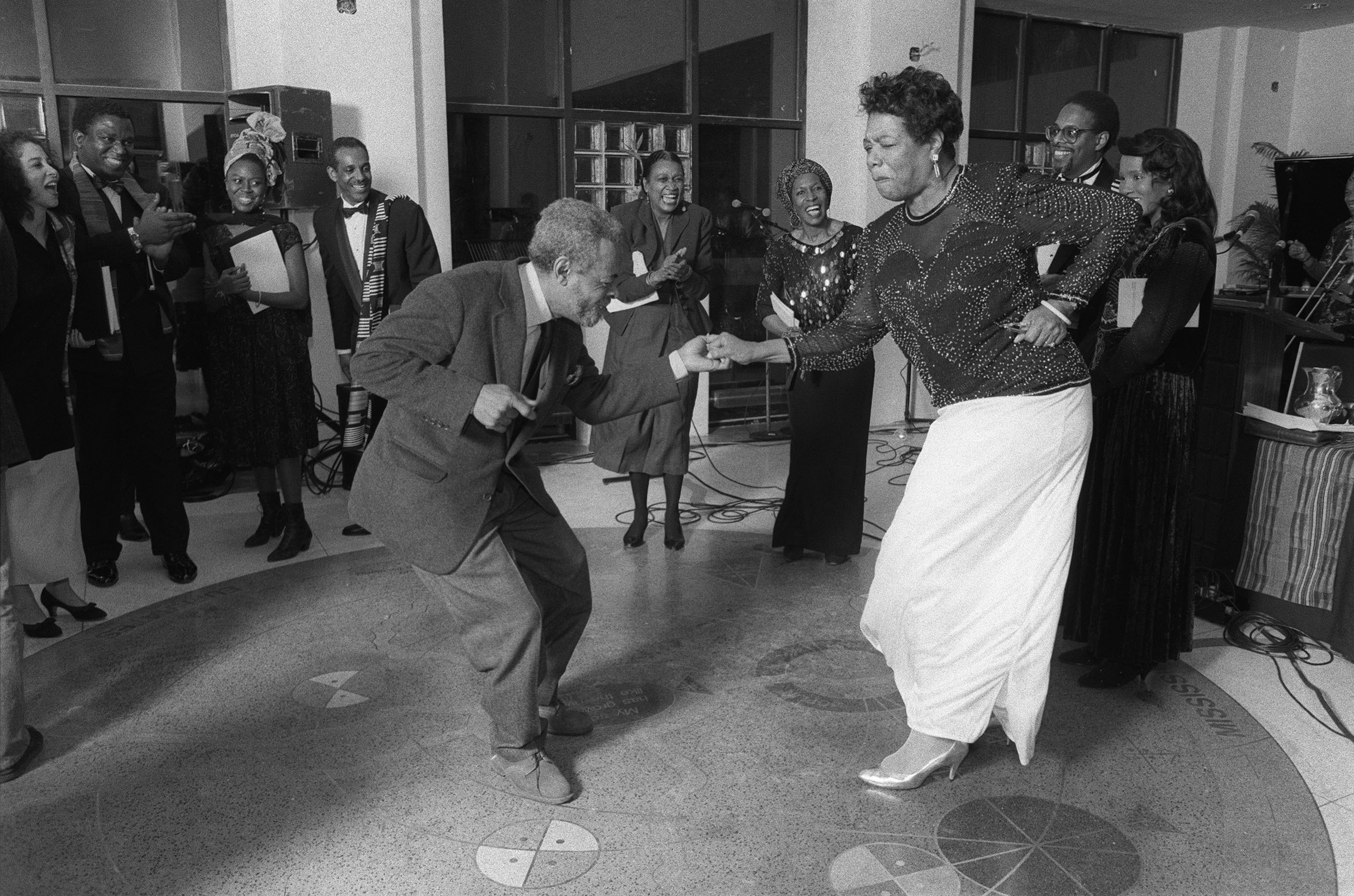 Poet Amiri Baraka and Maya Angelou dance during a celebration on the anniversary of poet Langston Hughes’s birth in New York, Feb. 22, 1991.