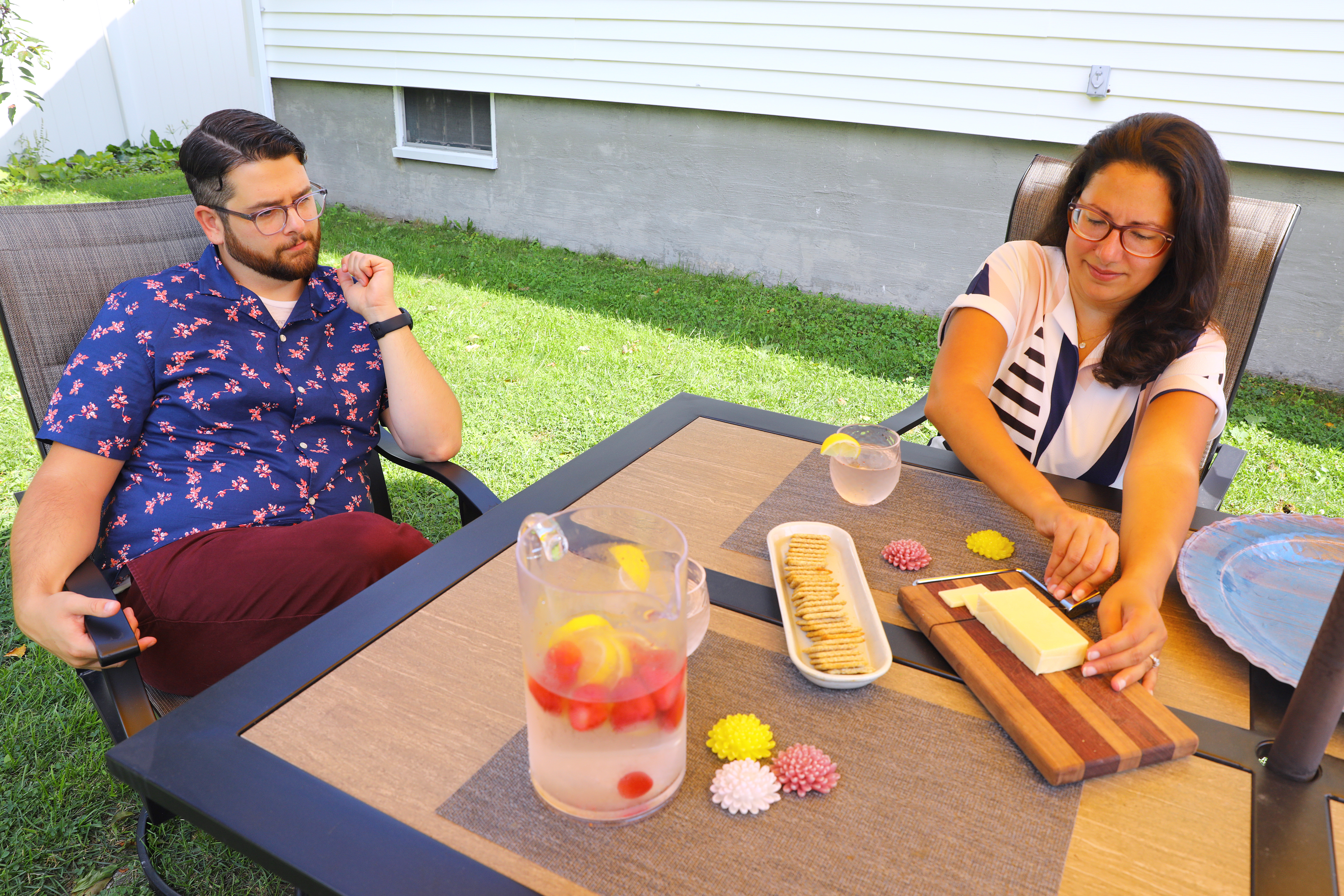Nic and Breanna DiBella take a break in their backyard with cold fruit-infused water and cheese and crackers. Some people, who are working from home during the coronavirus pandemic, have developed "shut-down rituals" to end their work day.