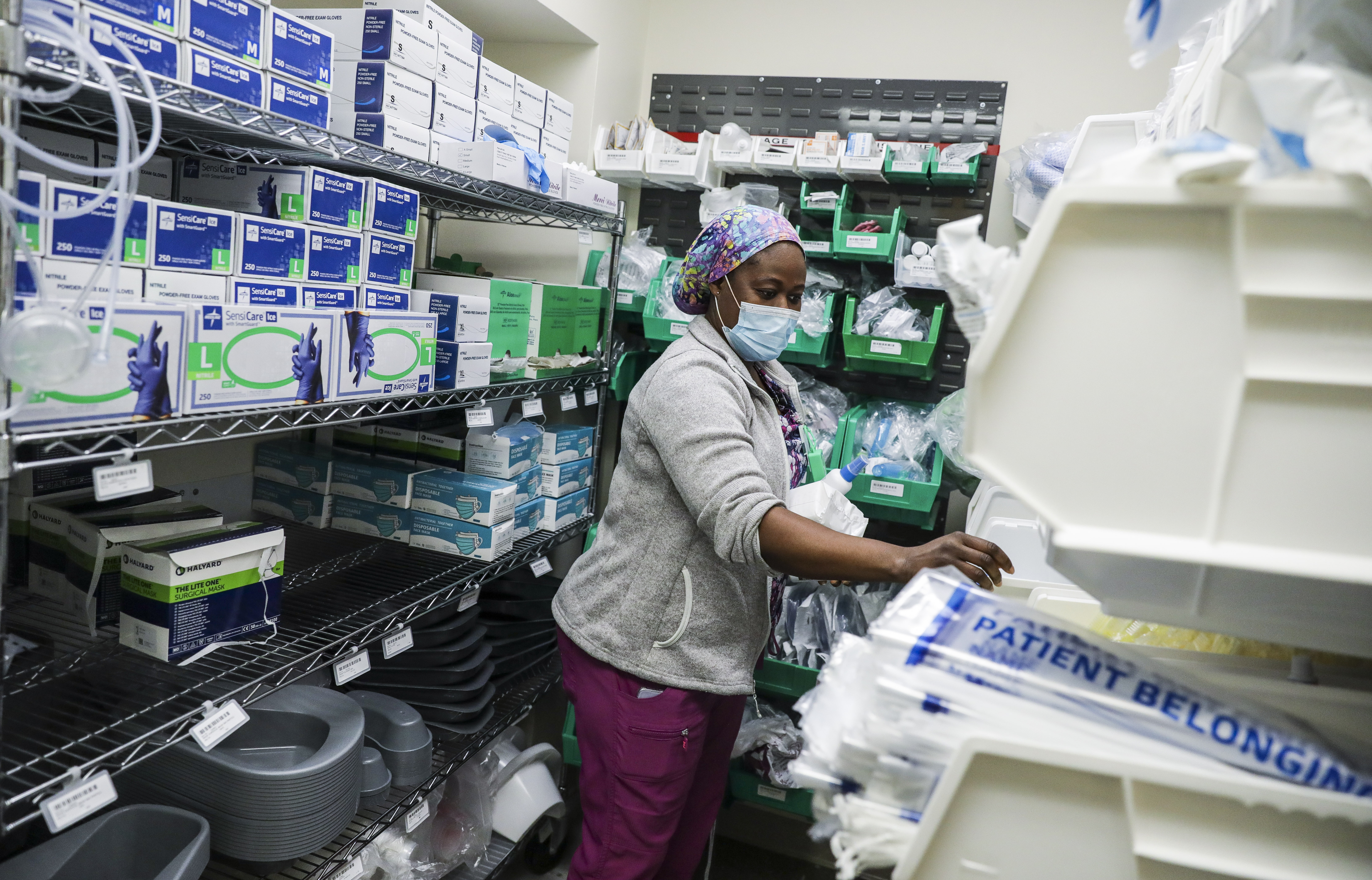 A hospital worker gathered supplies from a PPE closet at UMass Memorial Medical Center.